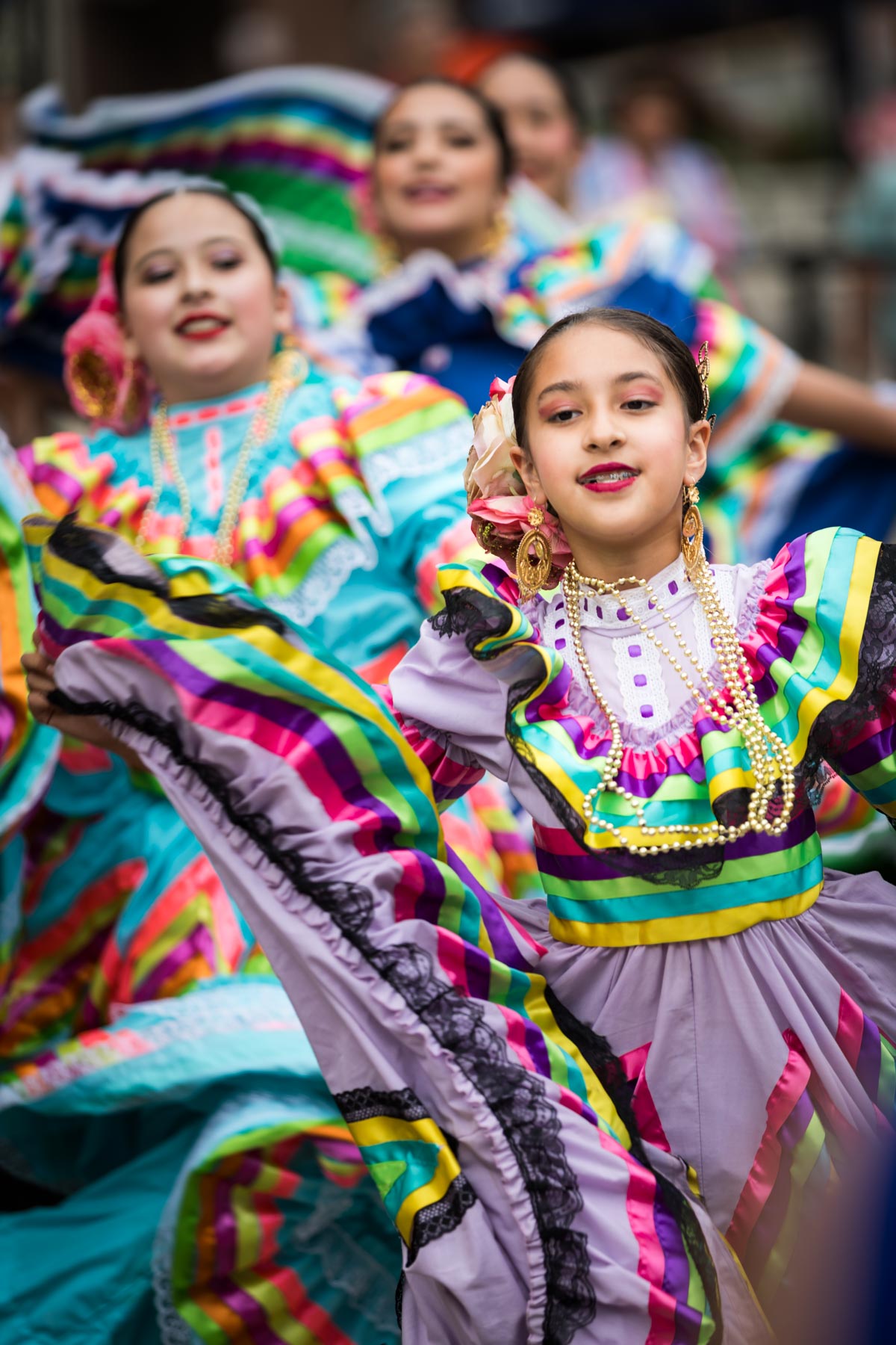 Little girls wearing colorful outfits at Rey Feo crowning for an article on the best Fiesta photos