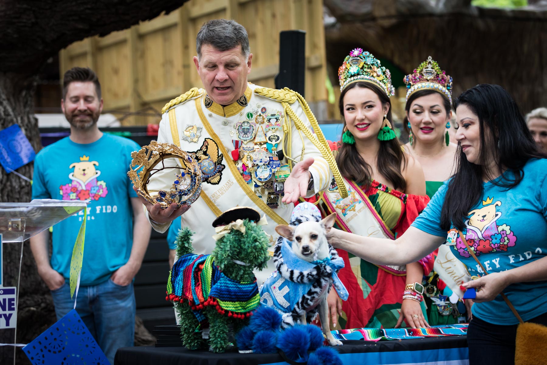 Rey Feo showing crown to female members of court and dog during Rey Fido event for an article on the best Fiesta photos