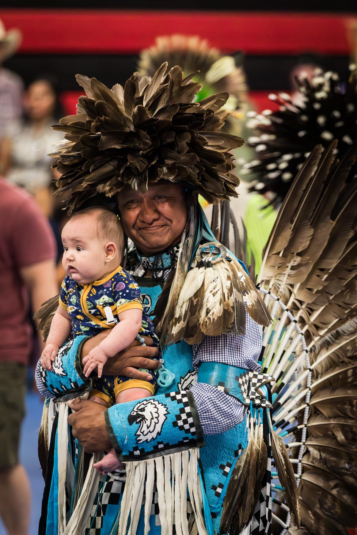 American Indian holding baby during pow wow for an article on the best Fiesta photos
