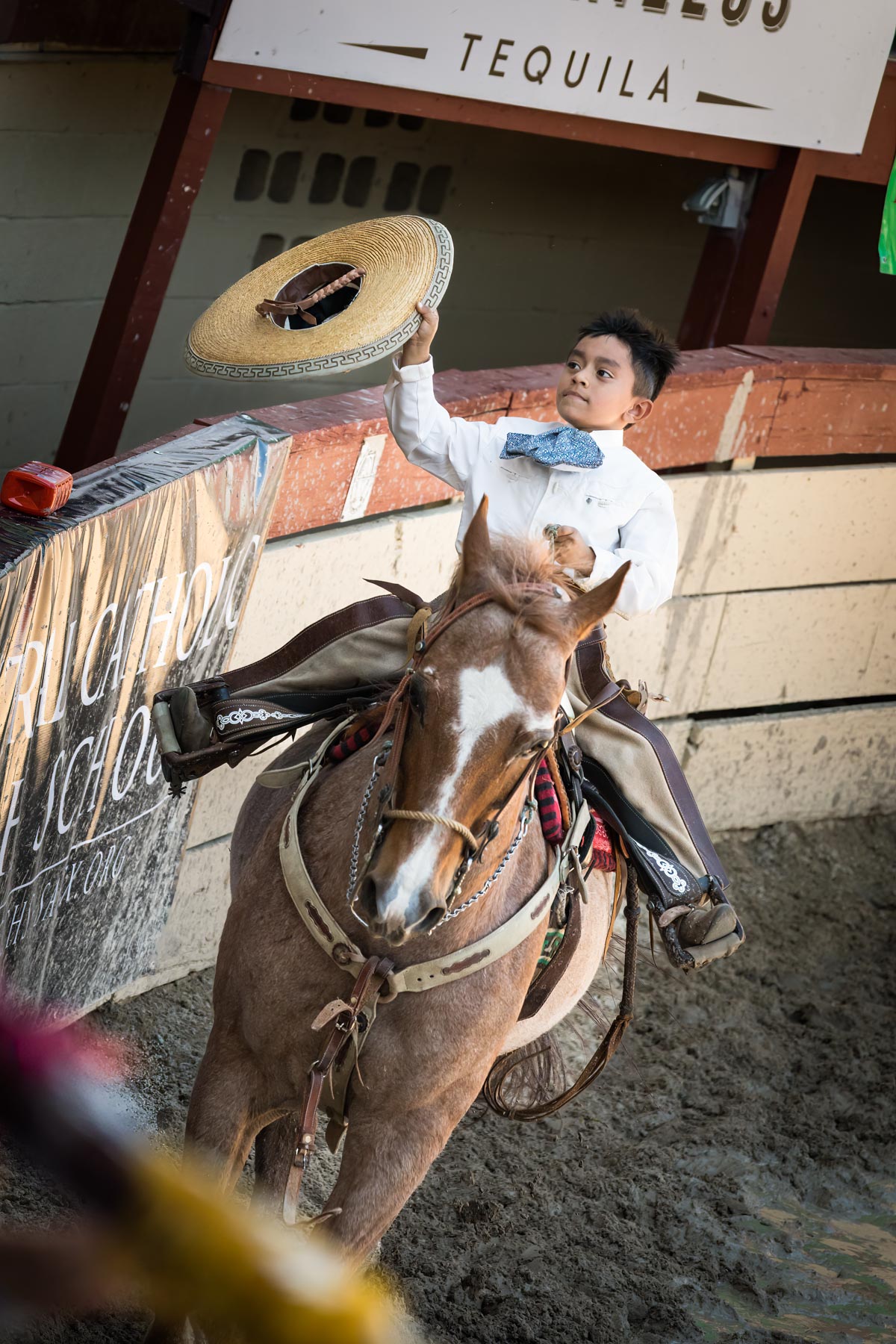 Little boy on horseback holding cowboy hat during Day at Old Mexico for an article on the best Fiesta photos