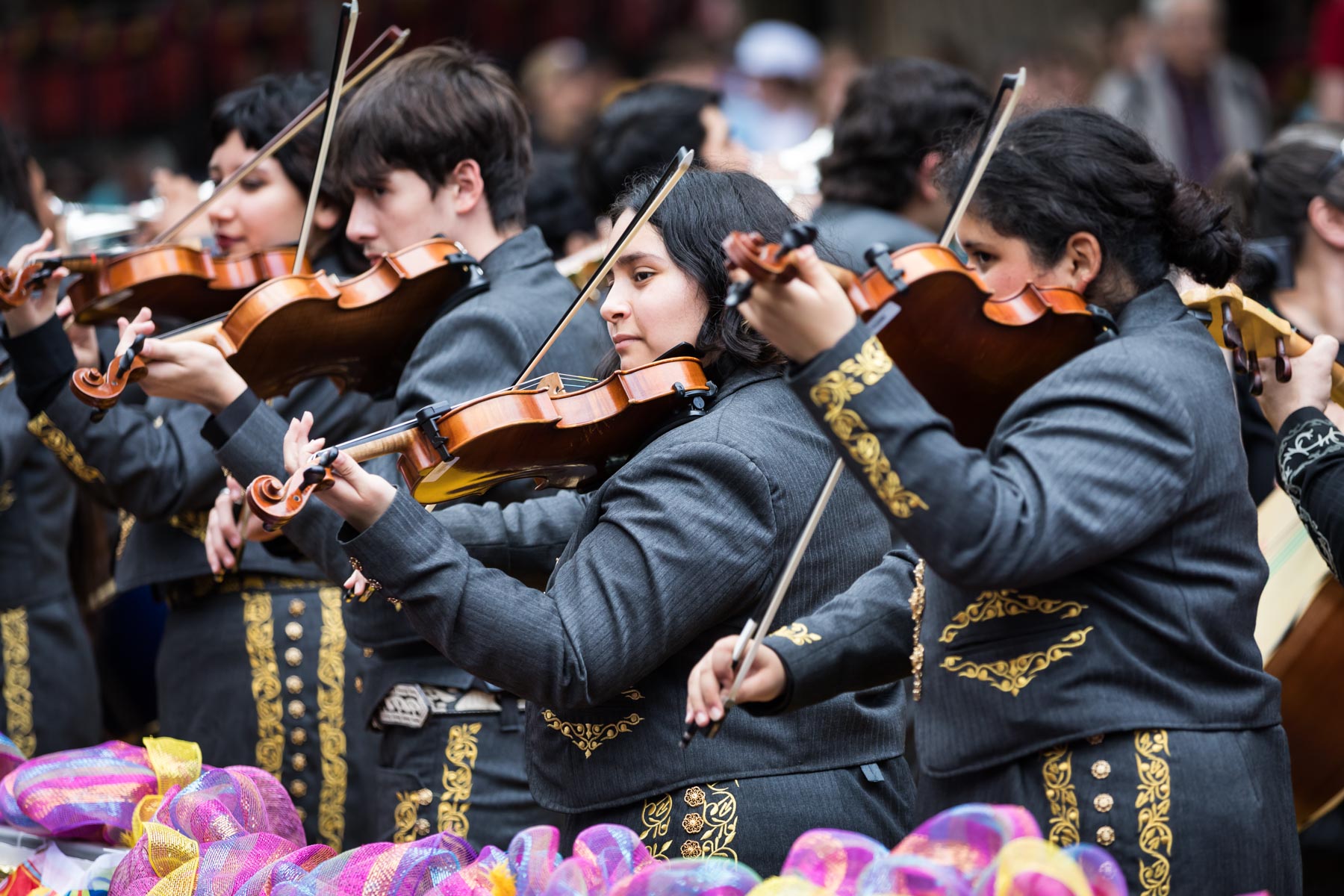 Mariachi musicians playing the violin for an article on the best Fiesta photos