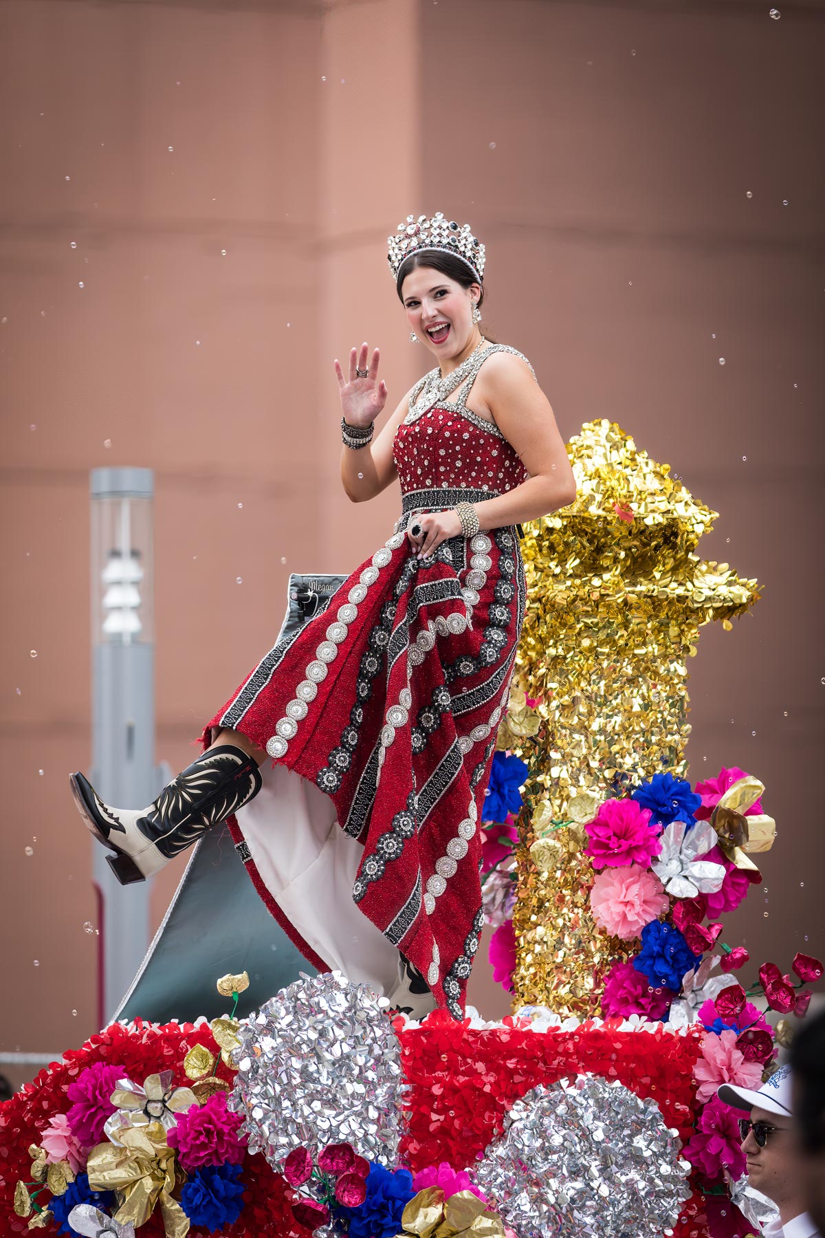 Queen on parade float showing off her boots for an article on the best Fiesta photos