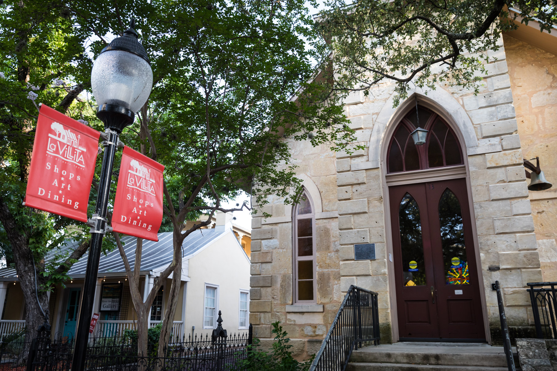Entrance to church with red sign in La Villita for an article on the perfect downtown San Antonio family portrait itinerary