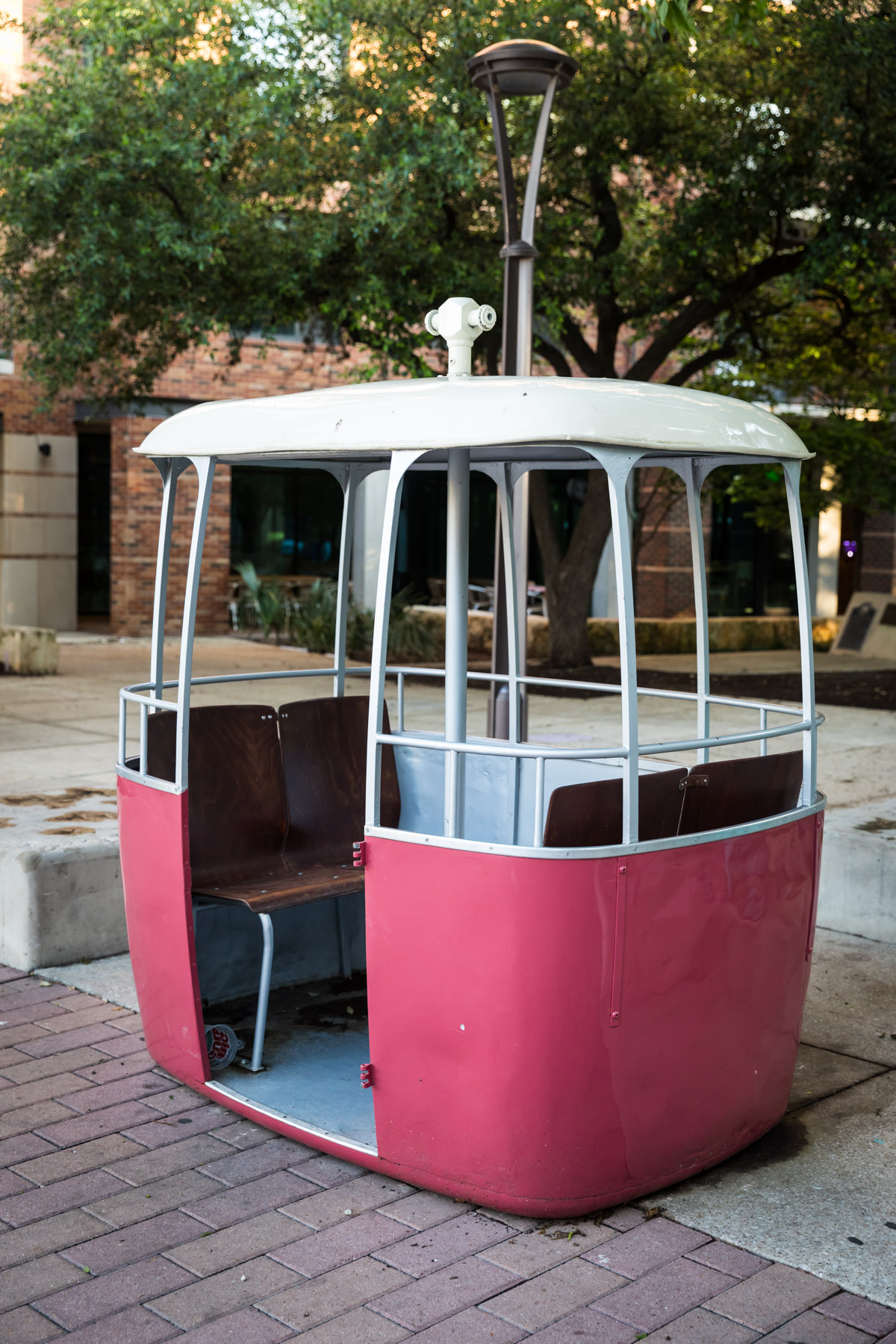 Old skyline gondola with red base in Yanaguana Garden in Hemisfair for an article on the perfect downtown San Antonio family portrait itinerary