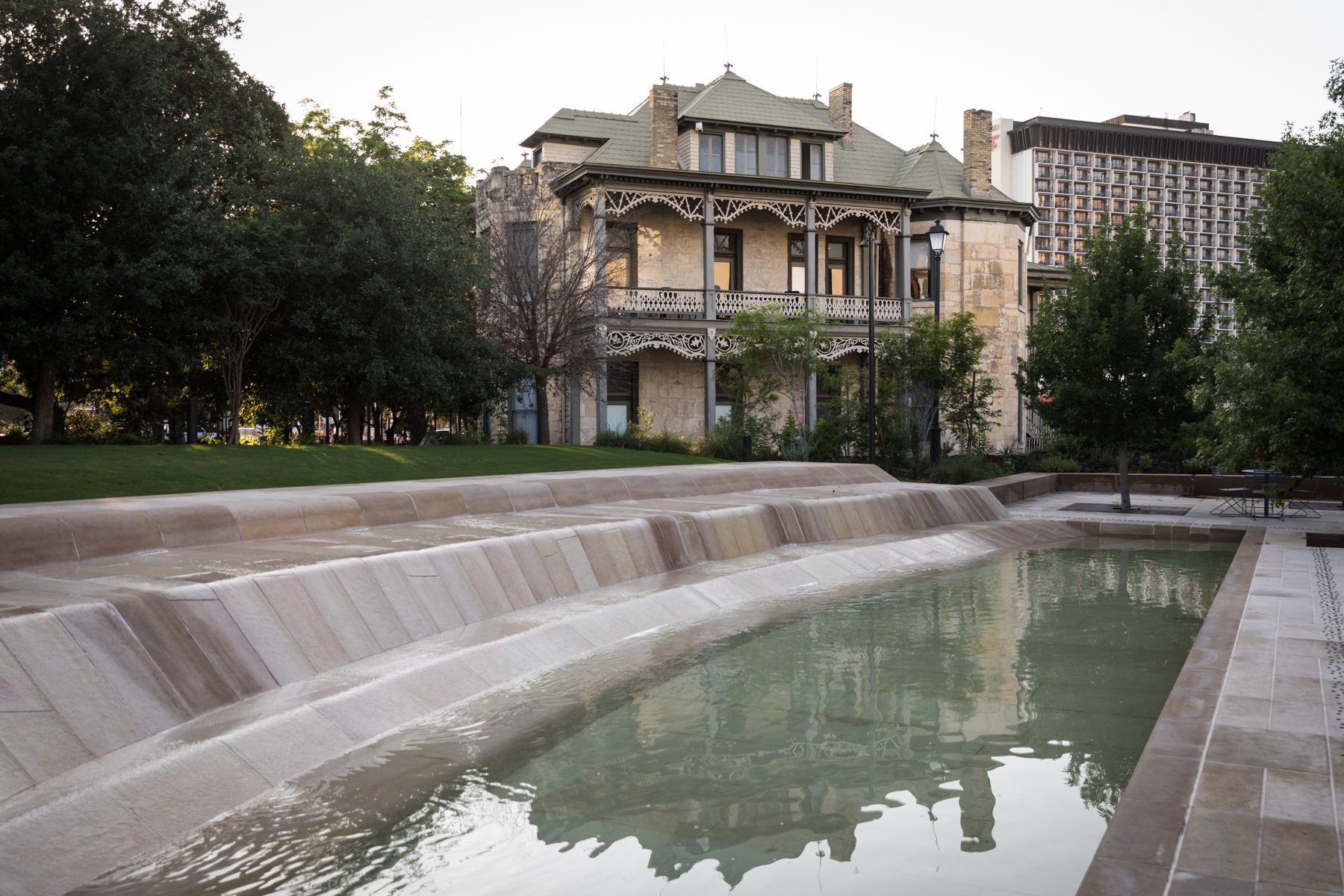 'River' fountain with old home in the background of Civic Park at Hemisfair for an article on the perfect downtown San Antonio family portrait itinerary