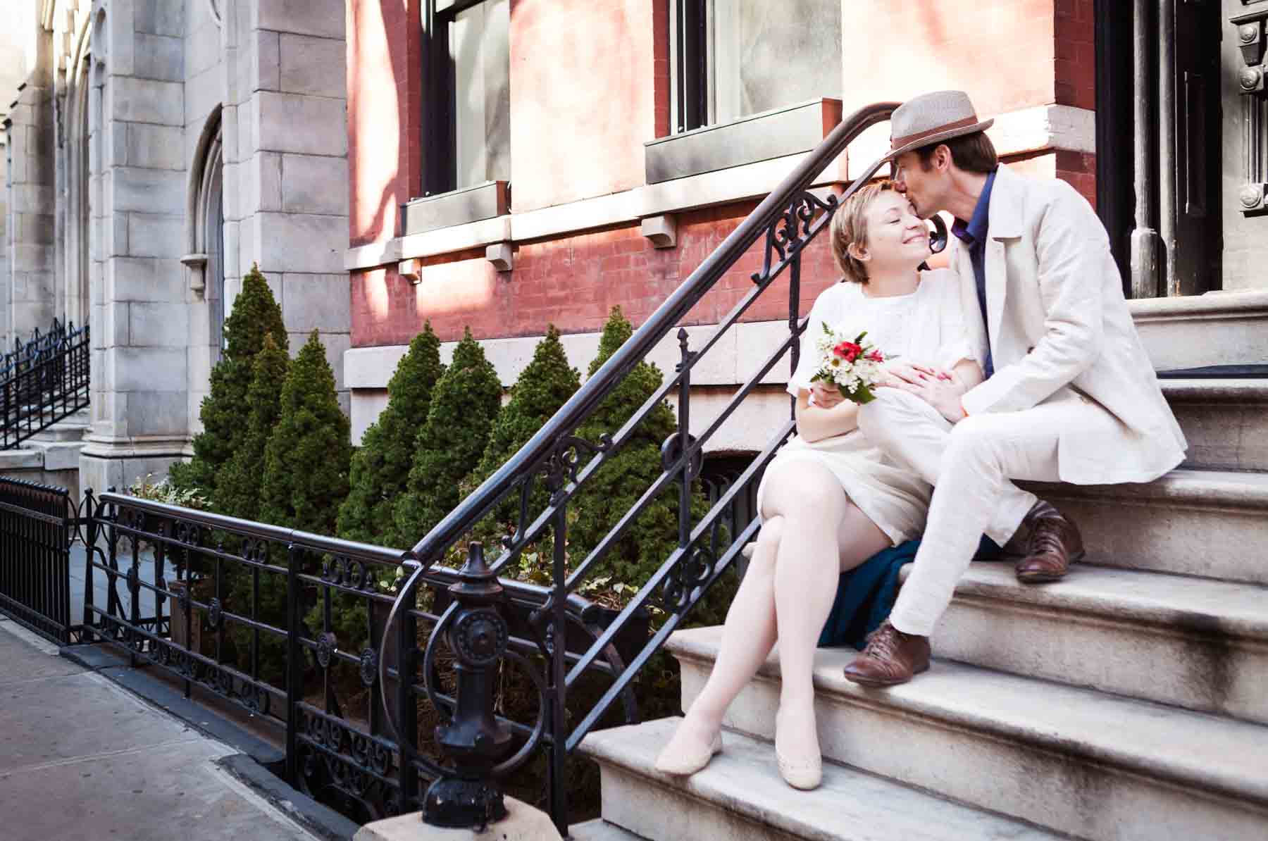 Man and woman sitting together on stairs leading to apartment for an article entitled, ‘Are Couples Still Getting Married?’