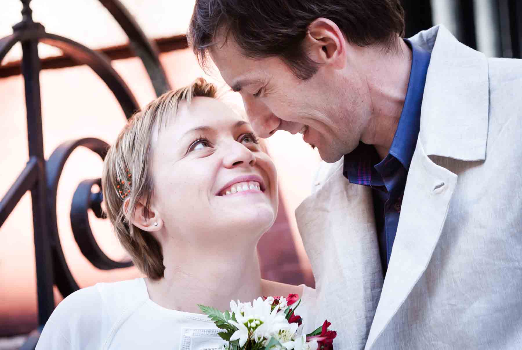 Close up of man and woman looking at each other for an article entitled, ‘Are Couples Still Getting Married?’