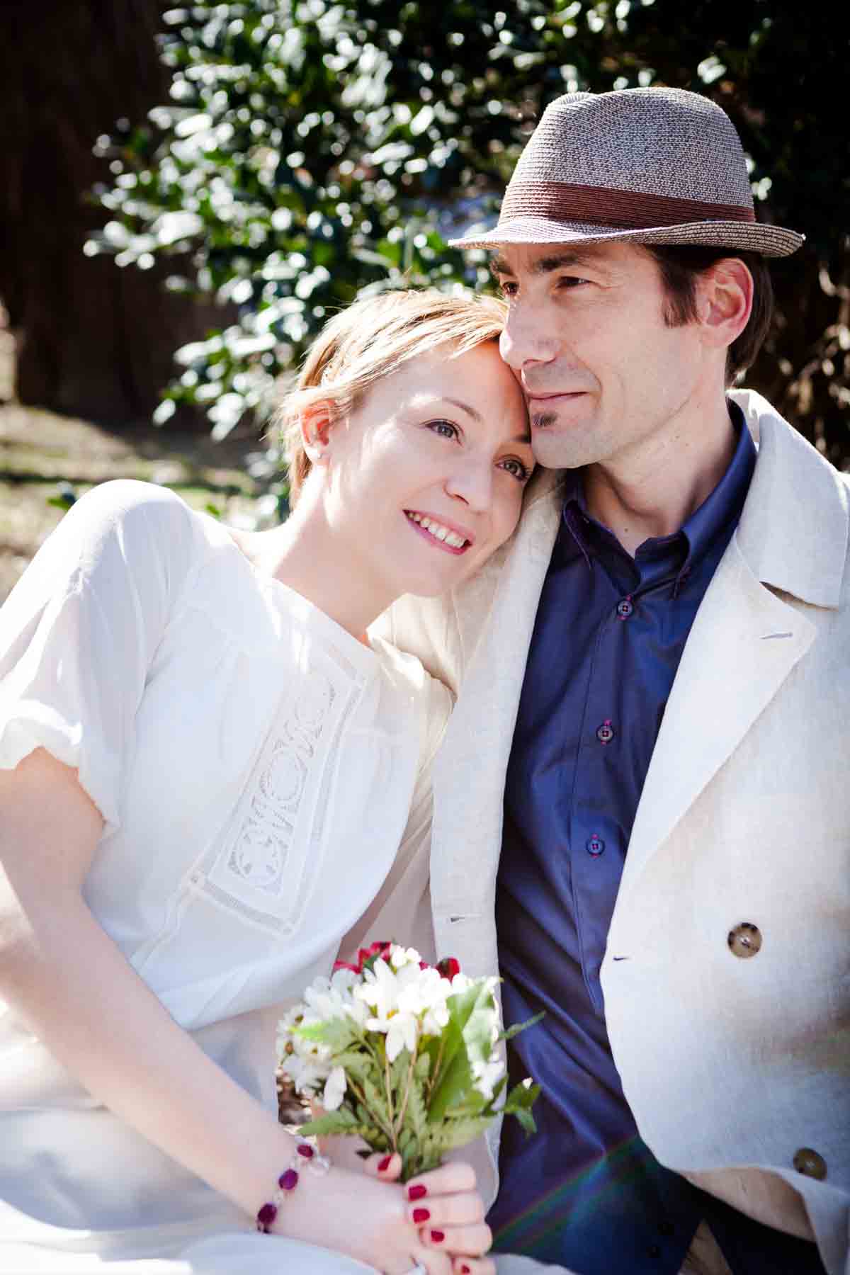 Woman with short hair putting head on man's shoulder for an article entitled, ‘Are Couples Still Getting Married?’