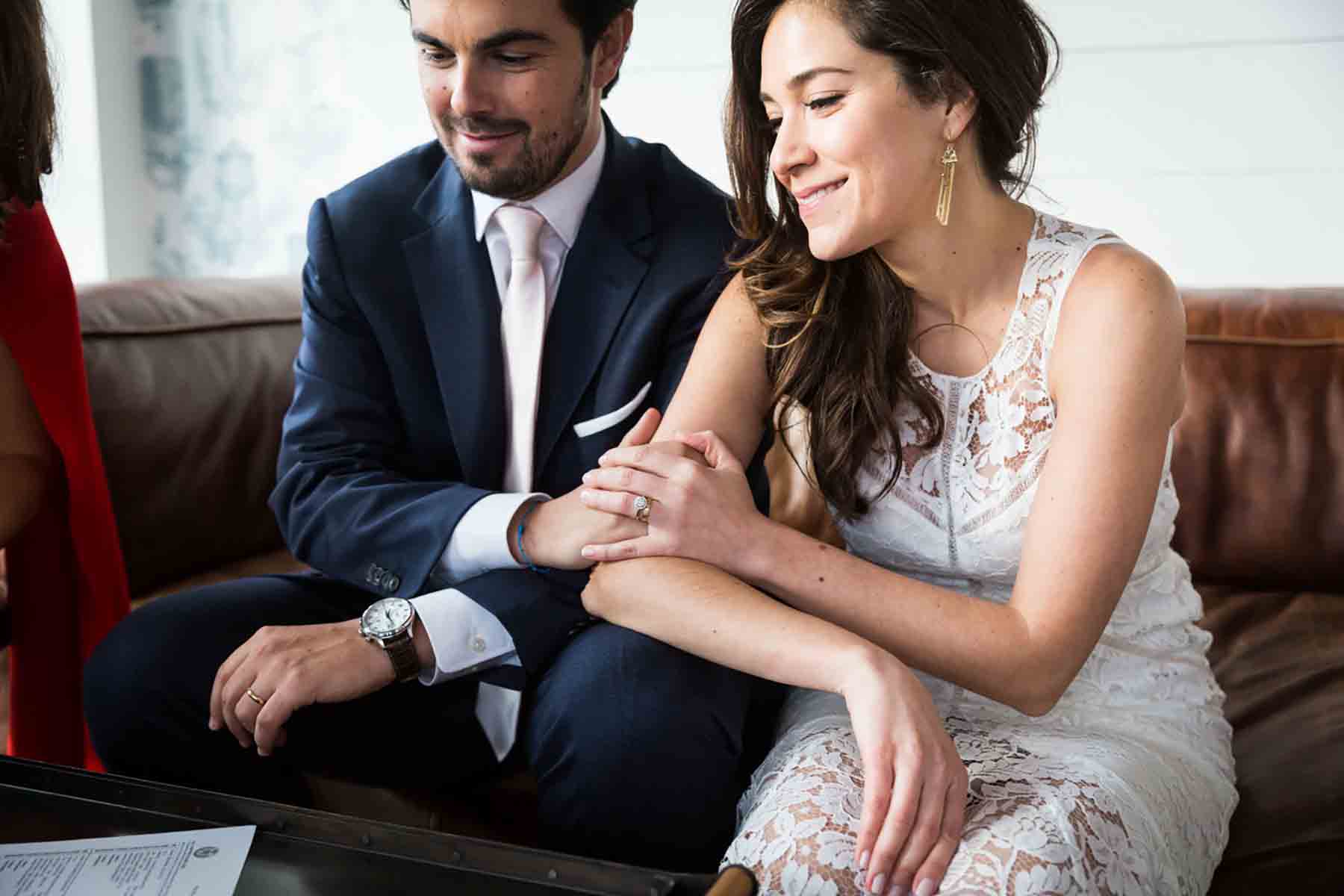 Bride and groom holding hands while sitting for an article on how to save money on wedding photography