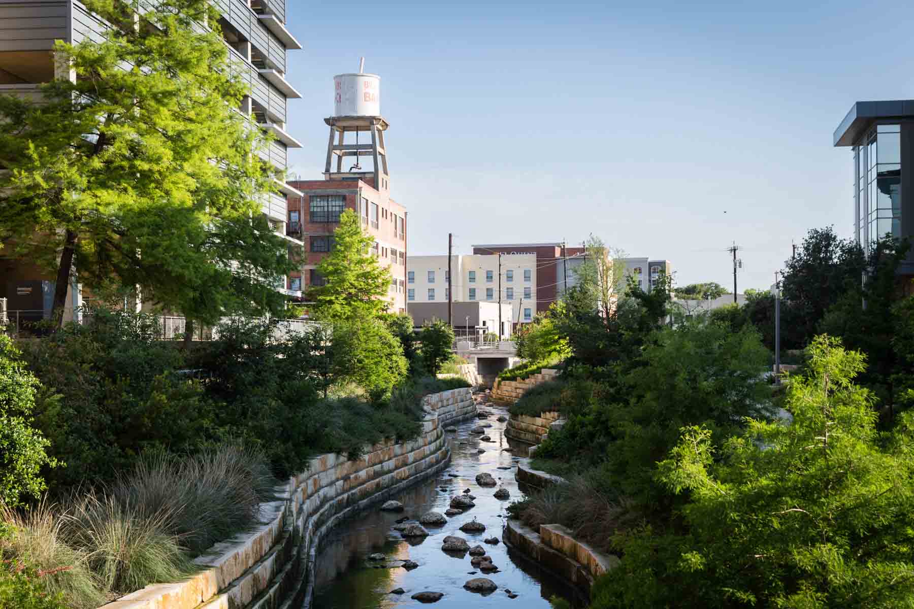 San Pedro Creek flowing through garden areas and buildings in downtown for an article on secret San Antonio photo shoot locations