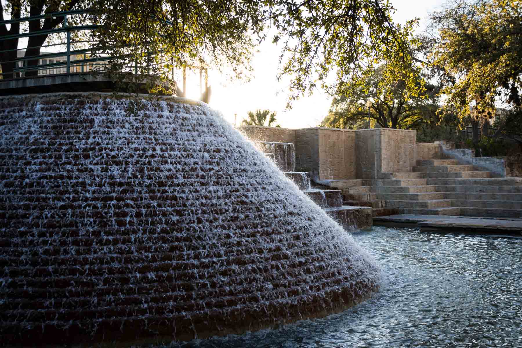 Water running down fountains in Tower of the Americas park area for an article on secret San Antonio photo shoot locations