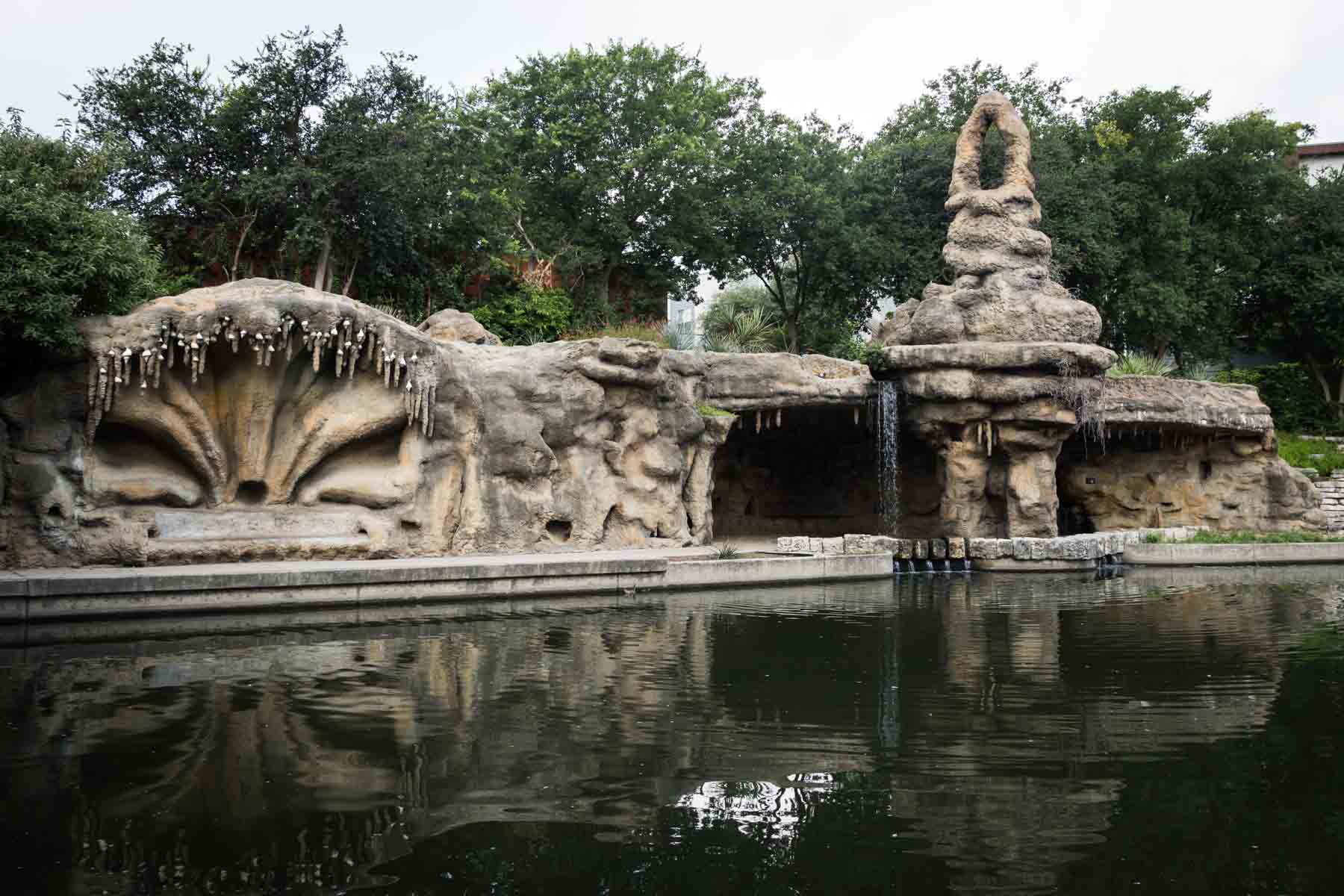 Grotto sculptures along river reflected in water for an article on secret San Antonio photo shoot locations