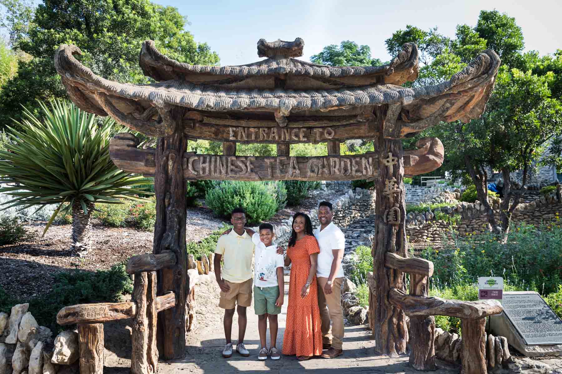 Japanese Tea Garden family portrait of a family standing in under the Asian-style entrance gate to the garden