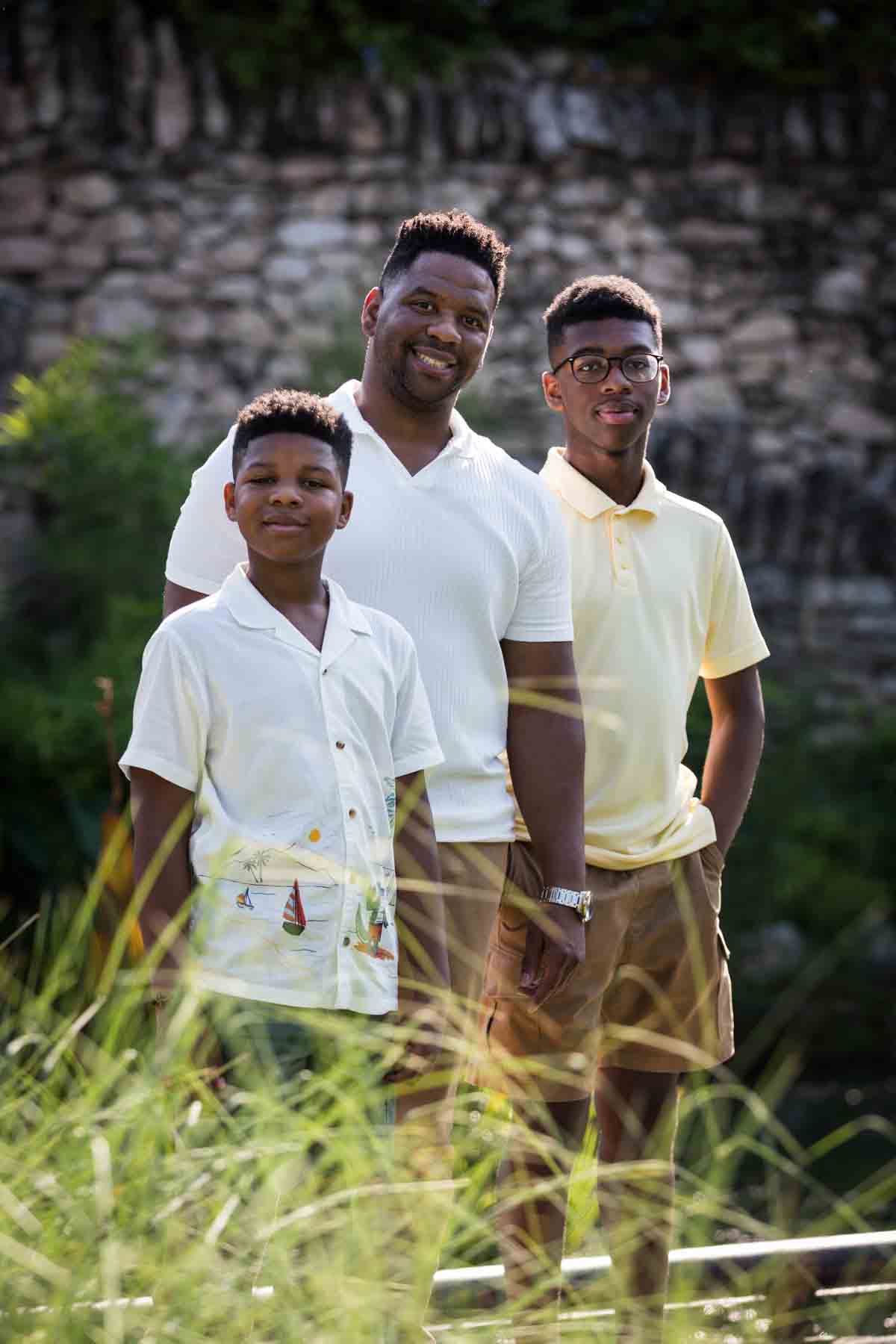 Japanese Tea Garden family portrait of an African American father and two sons standing in front of a stone wall