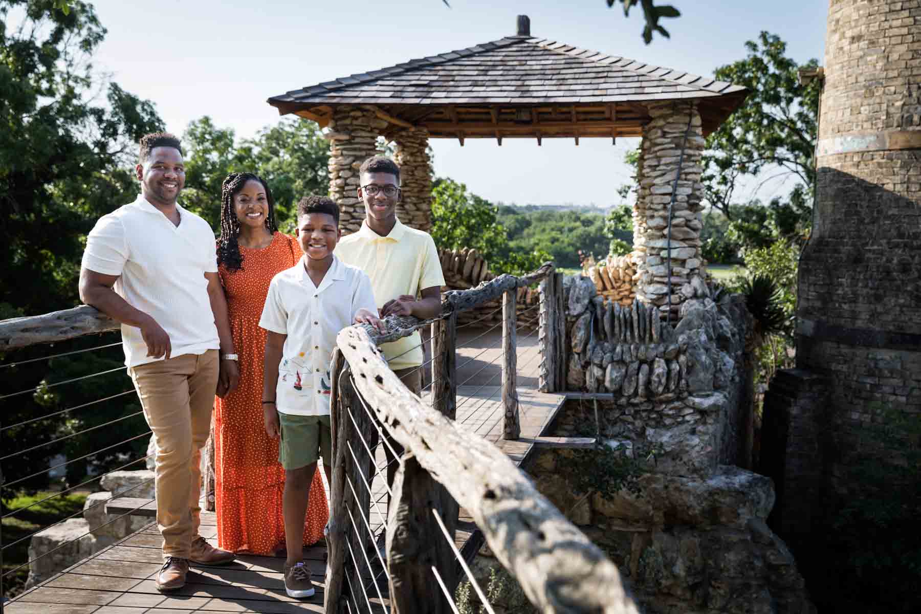 Japanese Tea Garden family portrait of a family standing in a wooden pathway leading to a rock-columned building