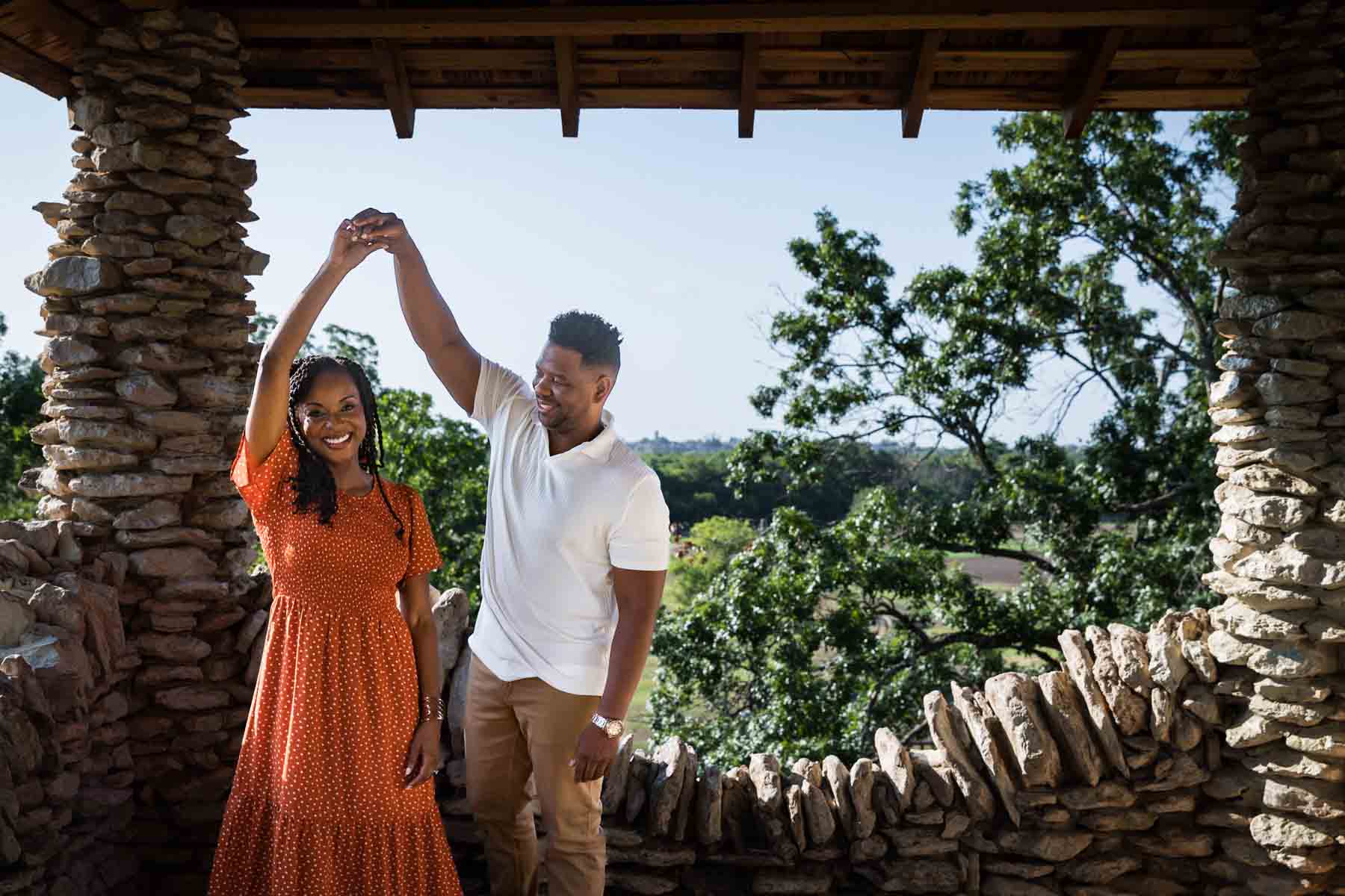 Japanese Tea Garden family portrait of an African American man and woman dancing under a roof looking out at a forest