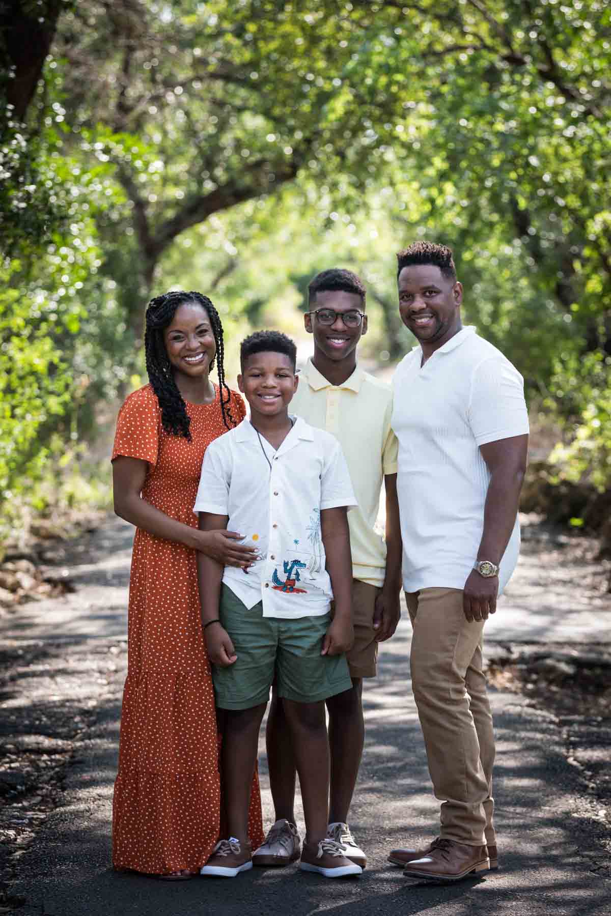 African American family of mother, father, and two sons standing in a forest for a Japanese Tea Garden family photo shoot