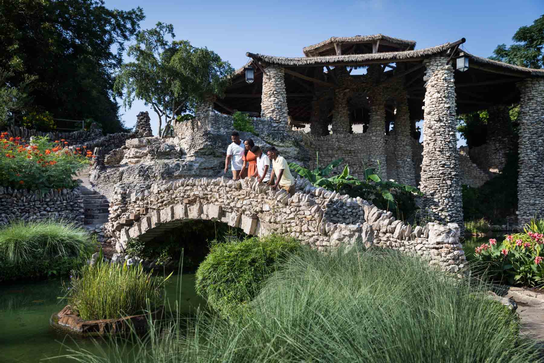 Japanese Tea Garden family portrait of an African American family standing on a stone bridge looking down into a pond