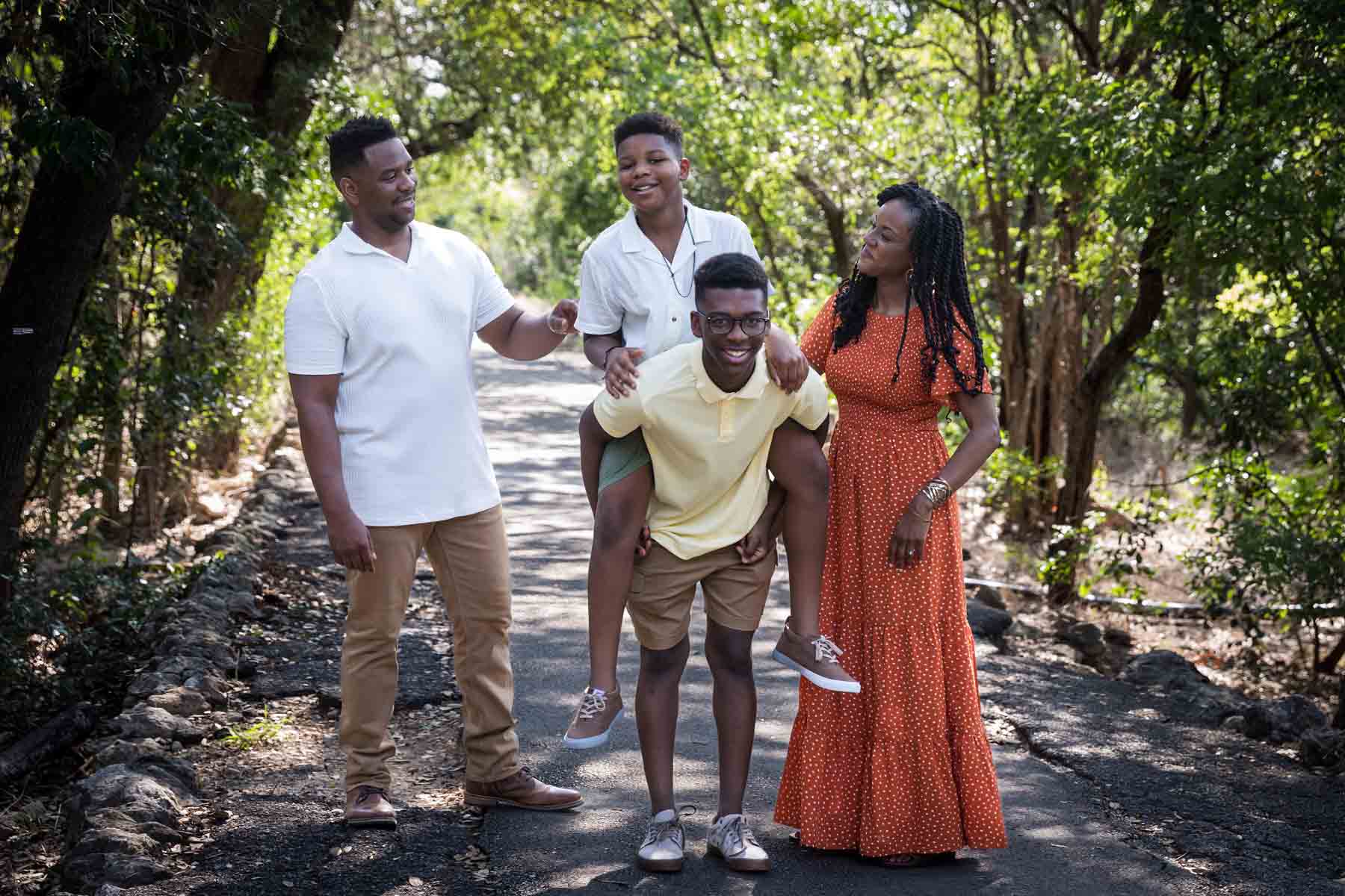 African American family of mother, father, and two sons standing in a forest for a Japanese Tea Garden family photo shoot