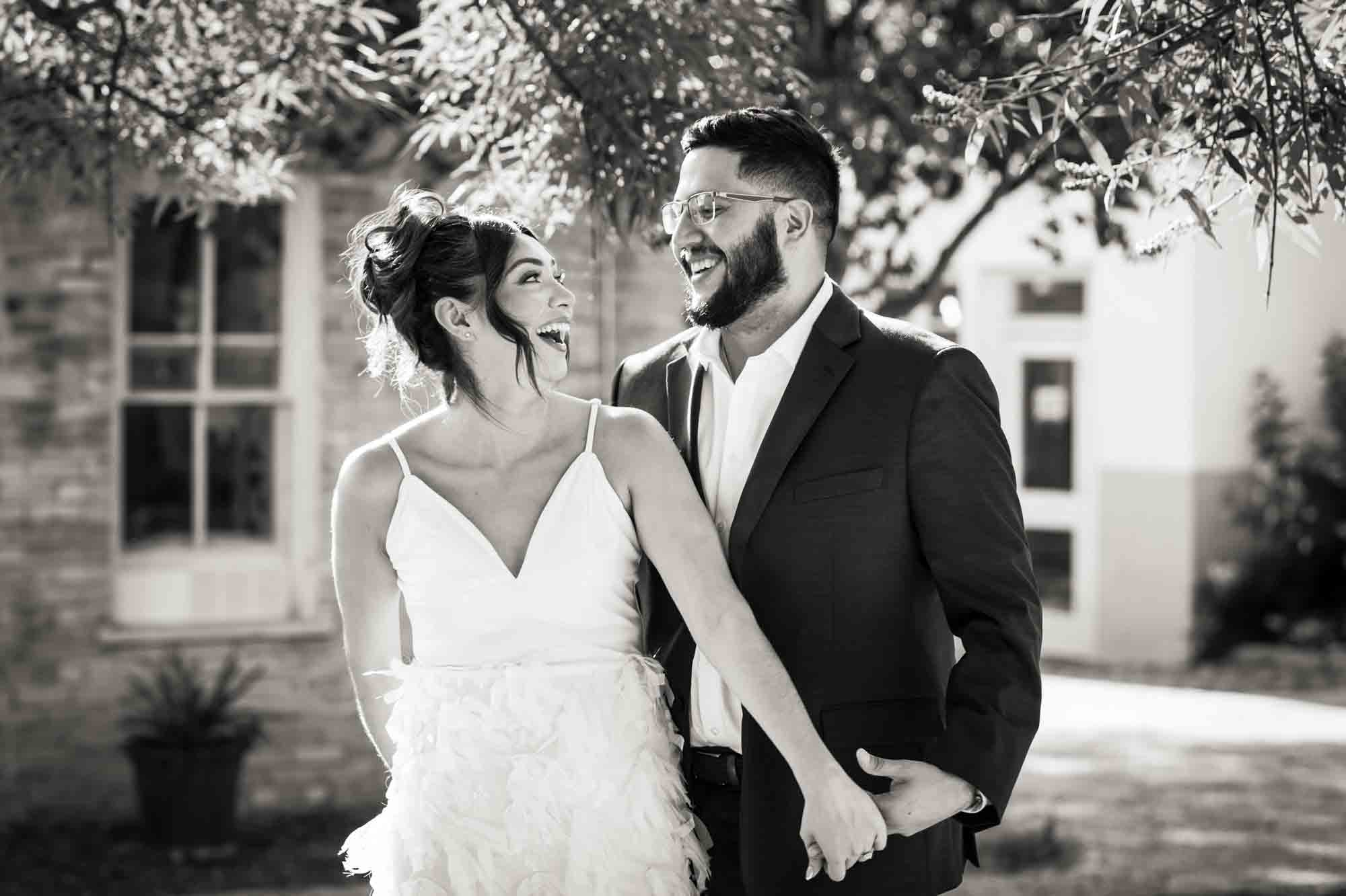 Black and white La Villita engagement photos of couple holding hands and looking at one another