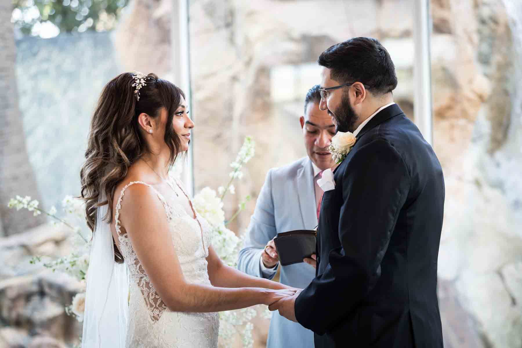 Old San Francisco wedding photos of bride and groom holding hands and looking at each other during ceremony