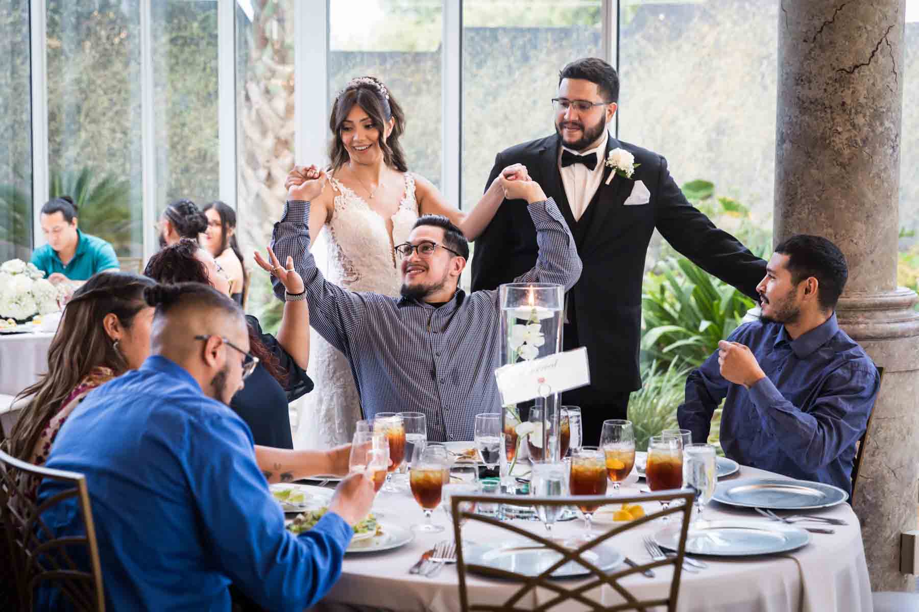 Bride and groom greeting table of friends during reception at an Old San Francisco Steakhouse wedding