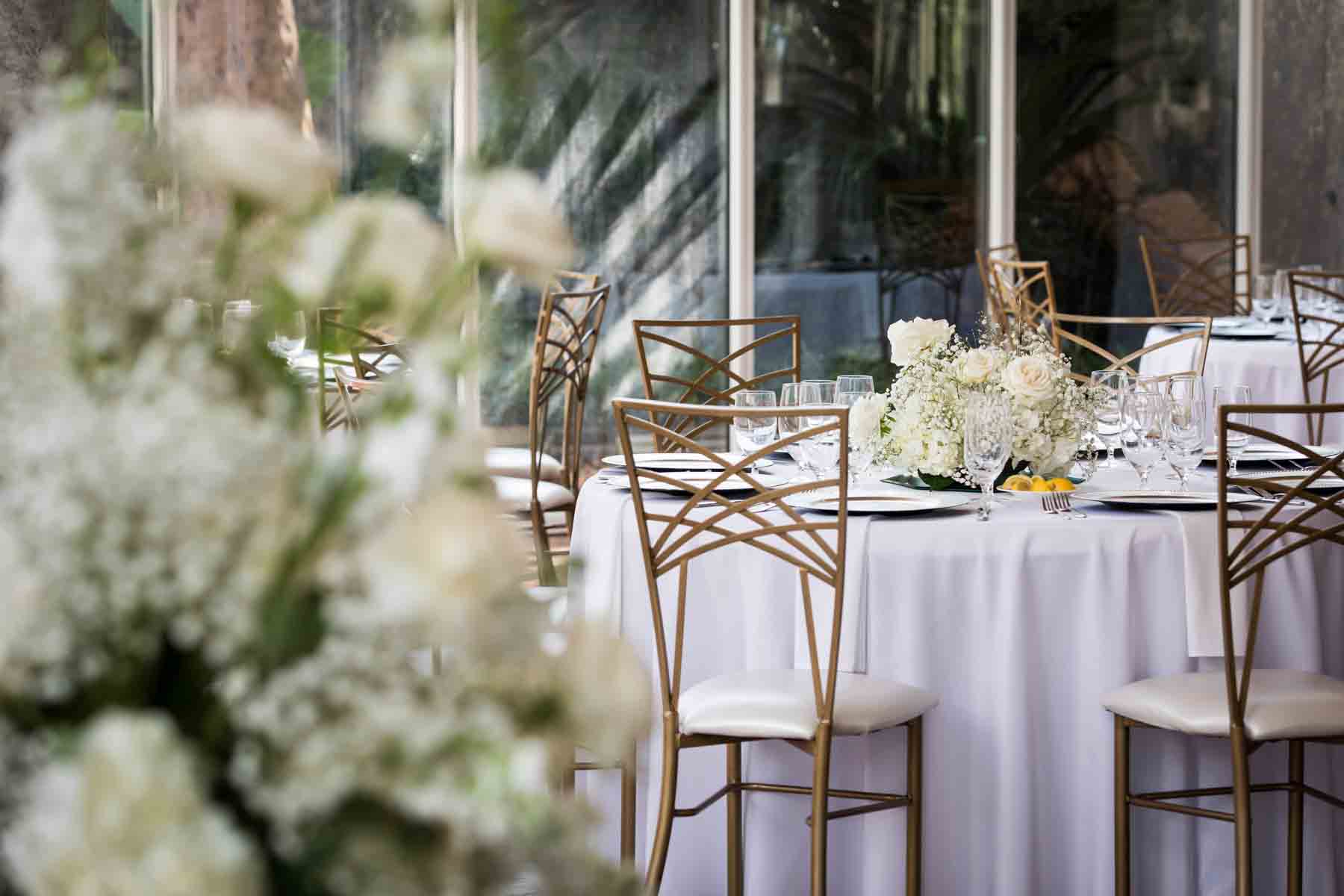 Table with centerpiece of white roses and babies breath at an Old San Francisco Steakhouse wedding