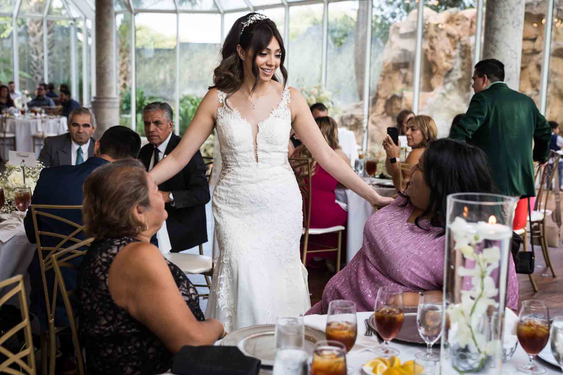 Bride greeting two female guests at a table during the reception at an Old San Francisco Steakhouse wedding