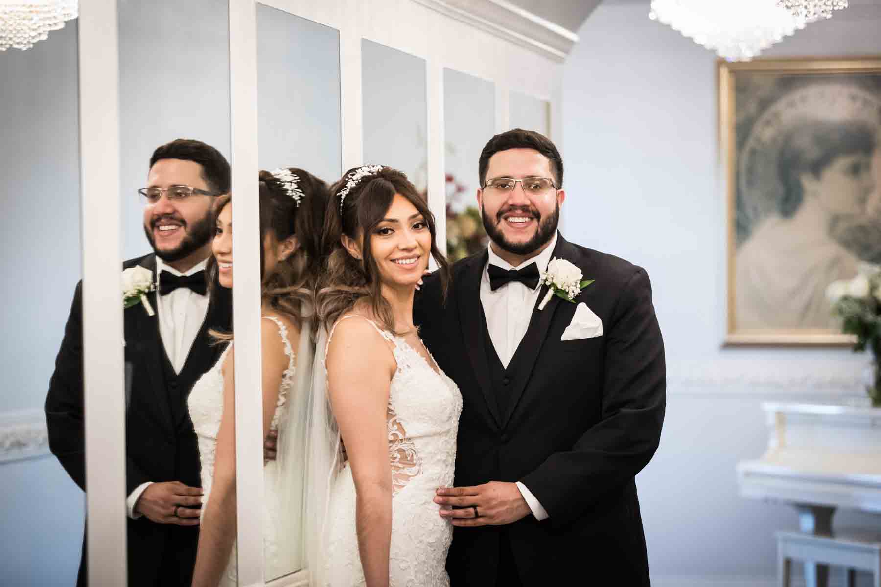 Bride and groom hugging as reflected in wall of mirrors at an Old San Francisco Steakhouse wedding