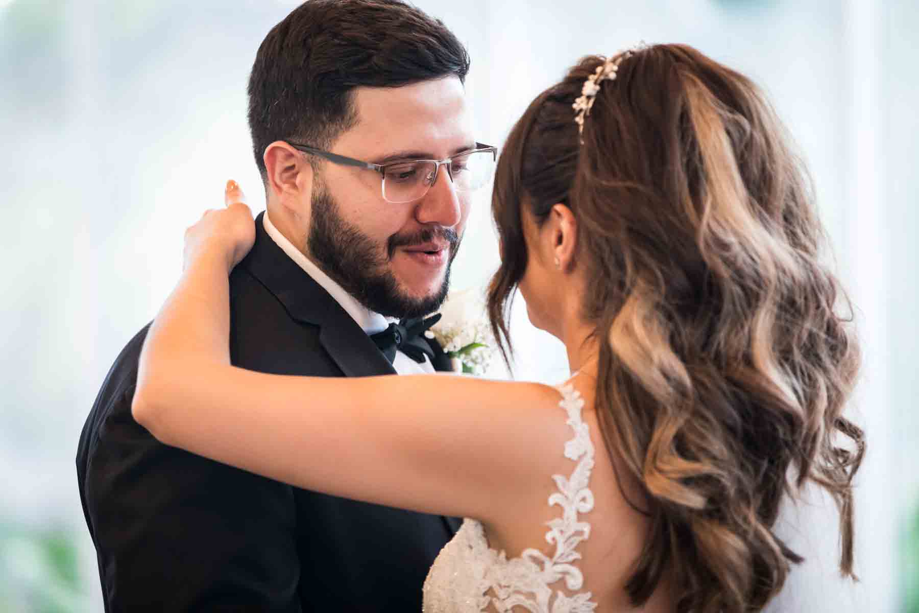 Old San Francisco wedding photos bride and groom dancing in front of glass wall