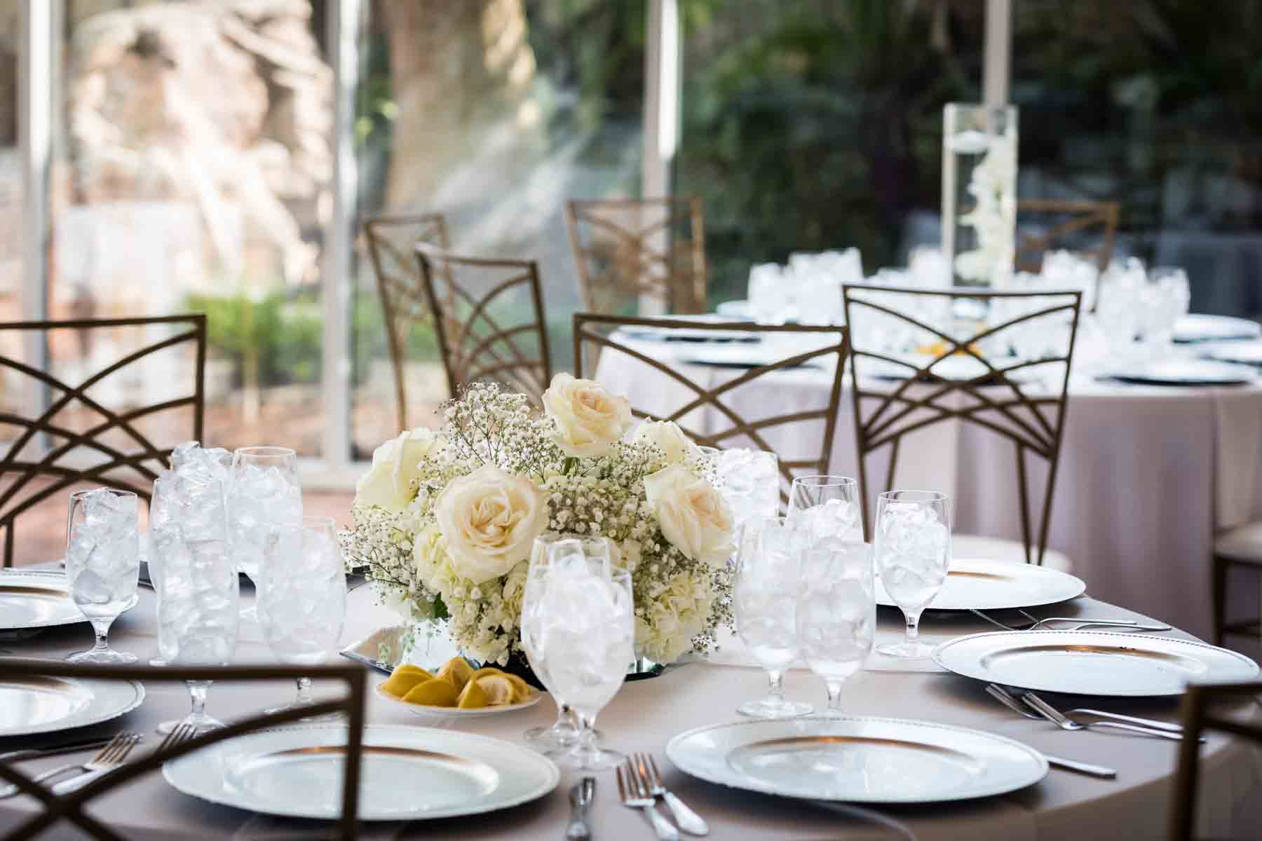 Table with white tablecloth and centerpiece of white roses and babies breath at an Old San Francisco Steakhouse wedding