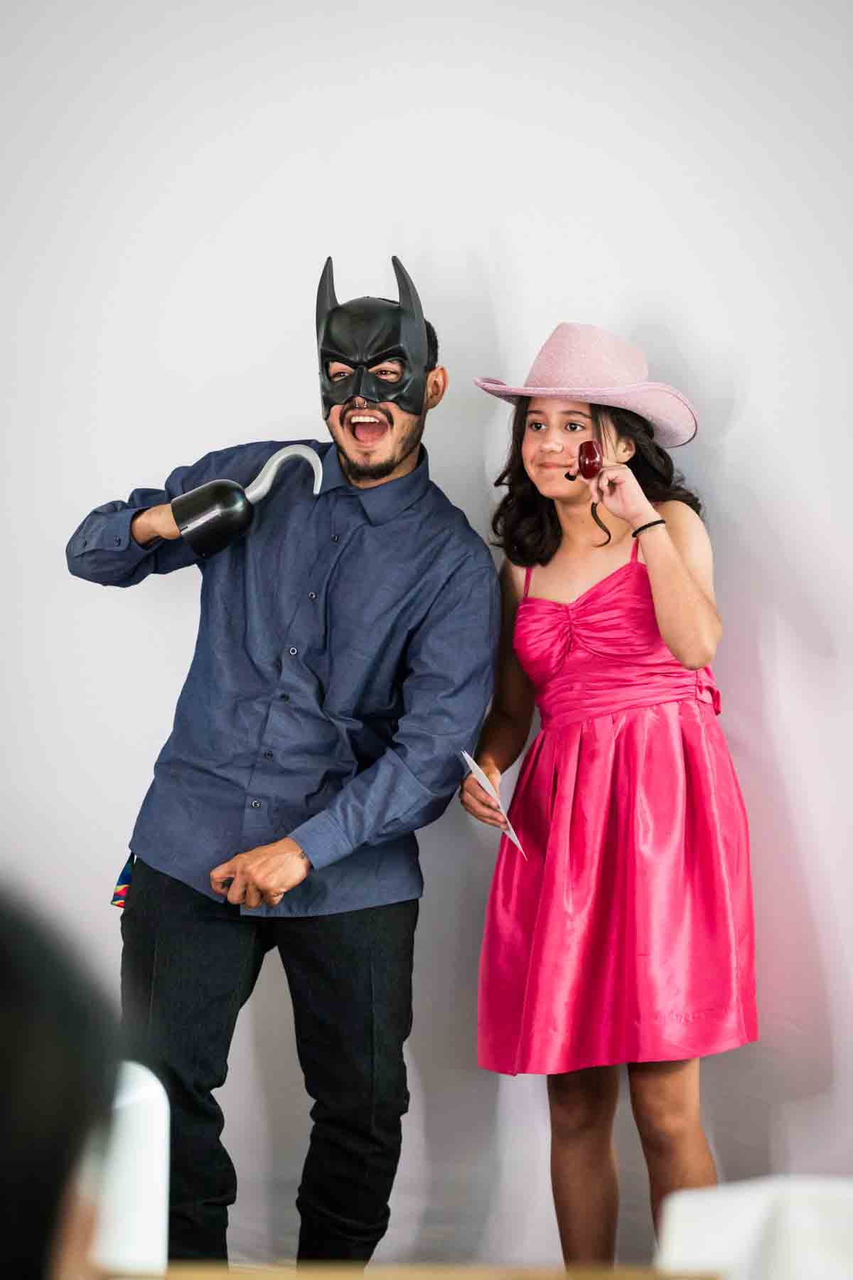 Guests dressed in batman mask and pink cowboy hat at an Old San Francisco Steakhouse wedding