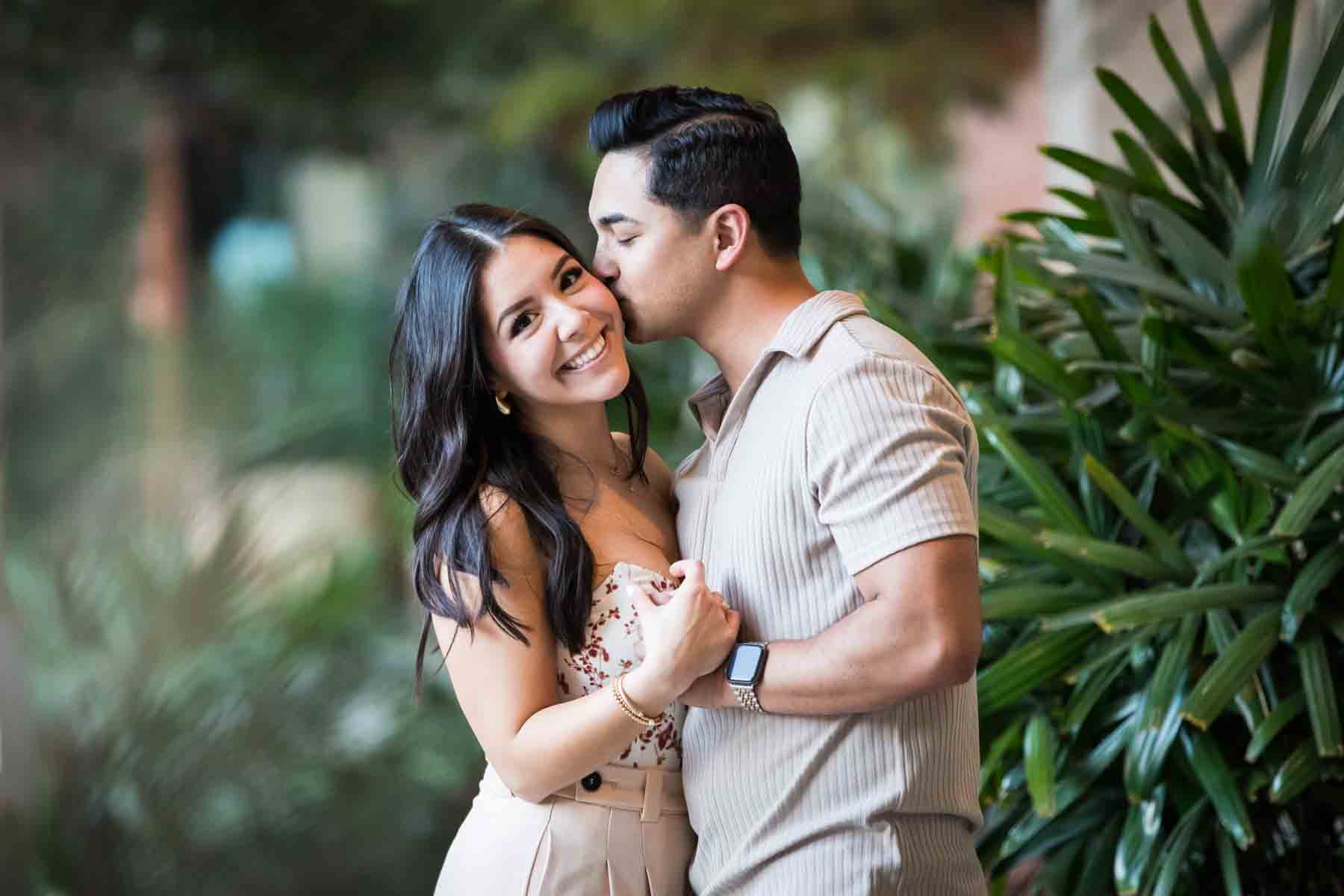 Couple dancing in front of palm trees at the Pearl