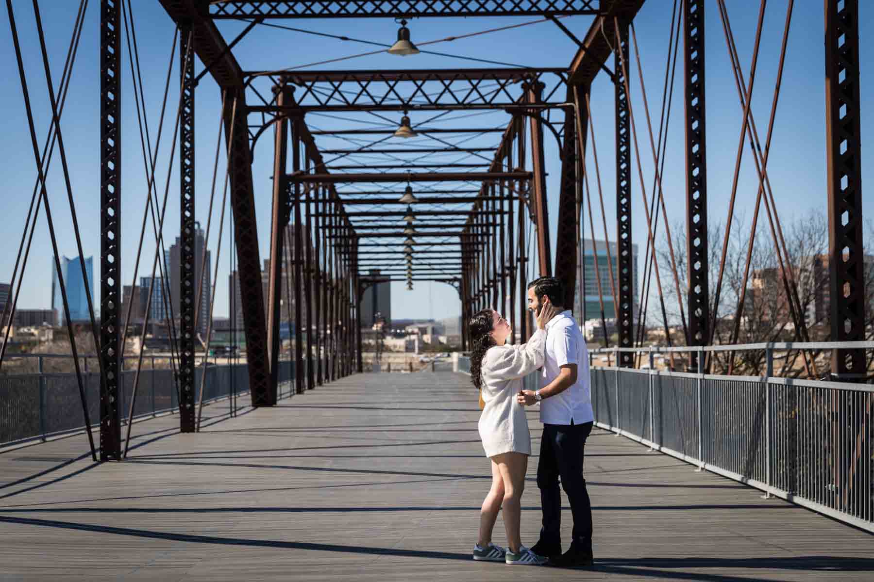 Couple kissing on Hays Street Bridge after proposal for an article listing the best places to propose in San Antonio