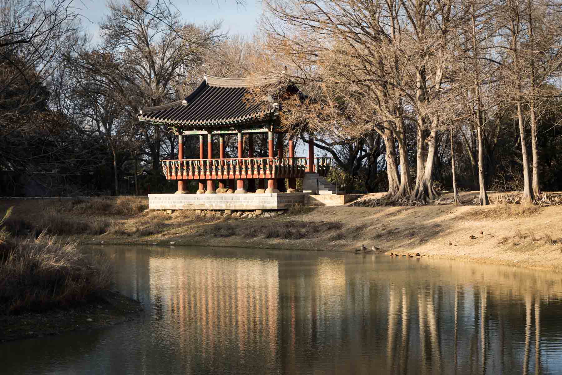 Korean monument behind lake at Denman Estate Park