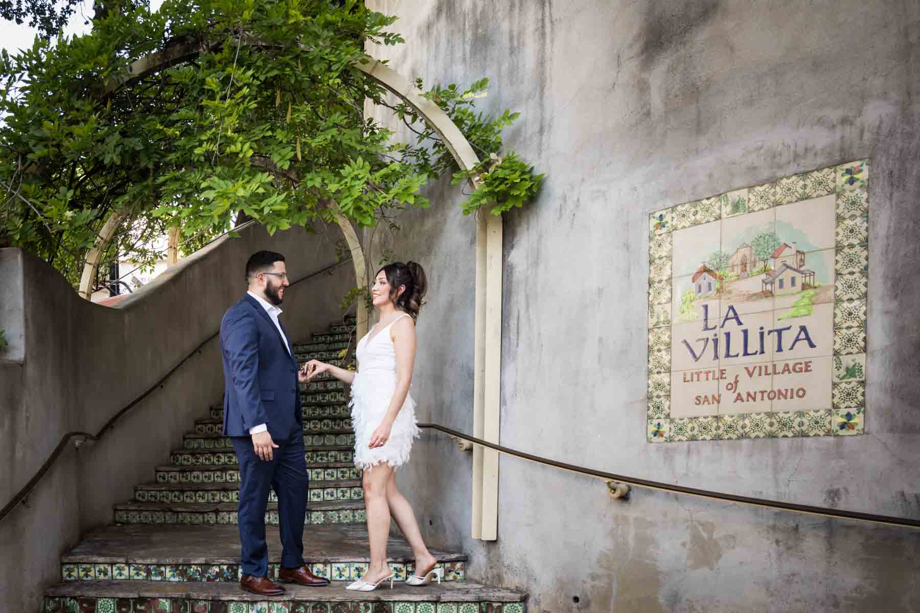 Couple holding hands on tiled staircase at La Villita