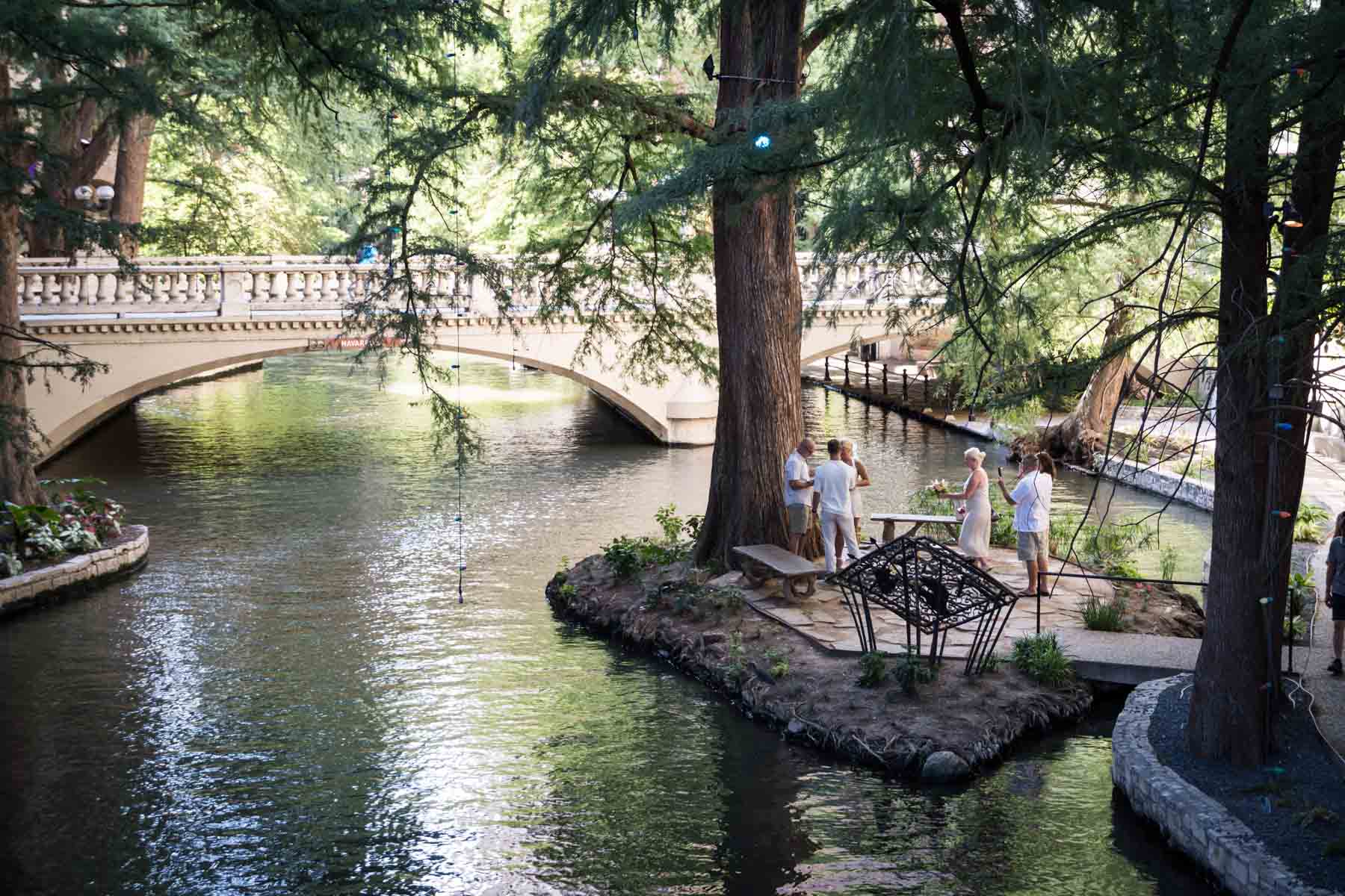 Couple exchanging vows on Marriage Island on the River Walk