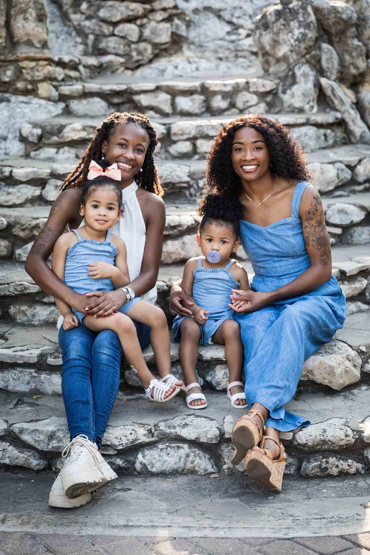 African American sisters and two little girls sitting on stone staircase at the Japanese Tea Garden for an article on 'How often should I take family photos?'