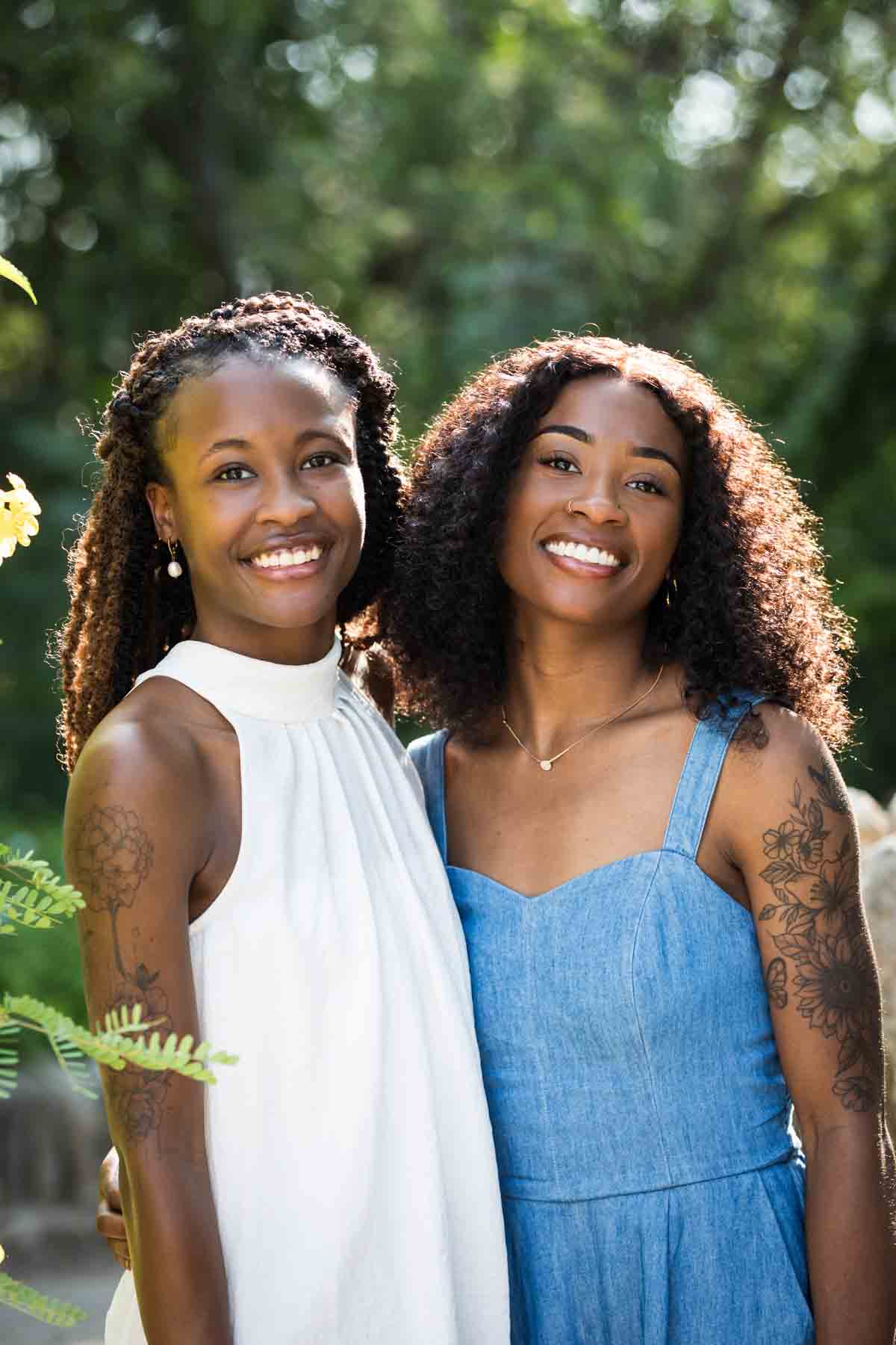 Two African American sisters wearing blue and white standing in the Japanese Tea Garden for an article on 'How often should I take family photos?'