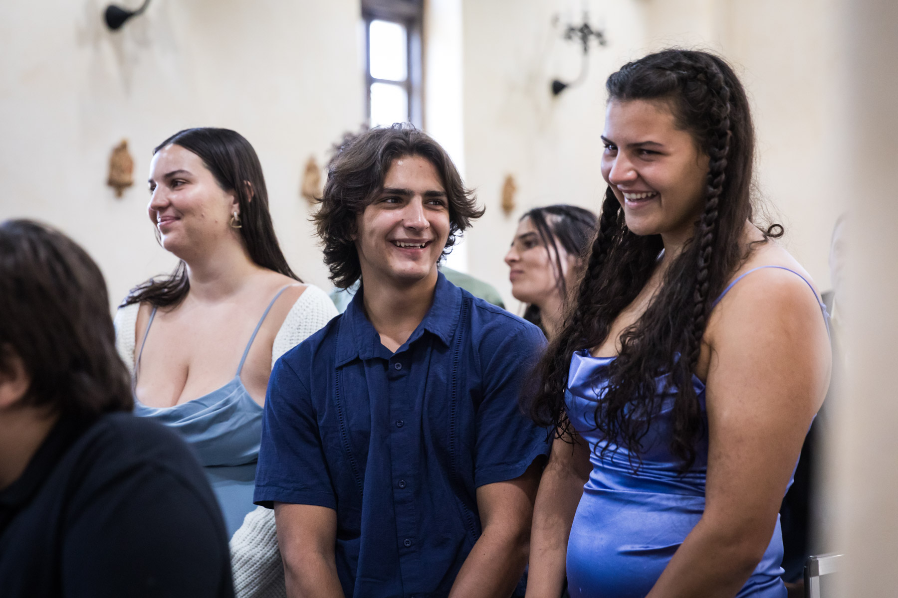 Guests smiling and laughing during ceremony for an article on how to get married at Mission Espada