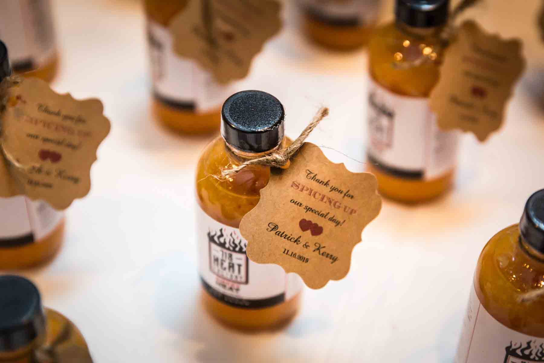 Close up of small bottles of hot sauce for guest favors