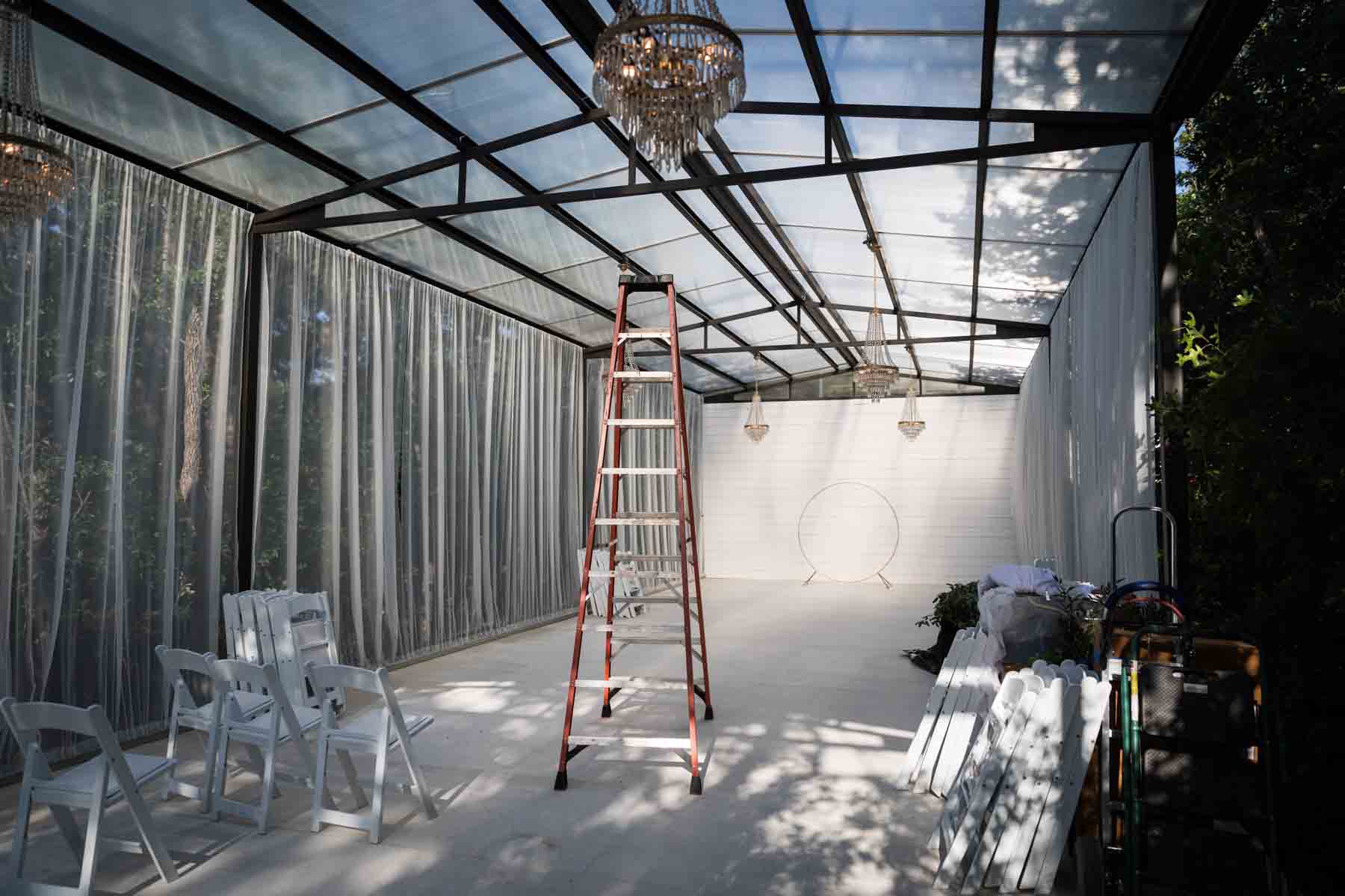 Empty room with ladder in the middle of the room before florist begins for an article on how to choose the perfect flowers for your wedding or event