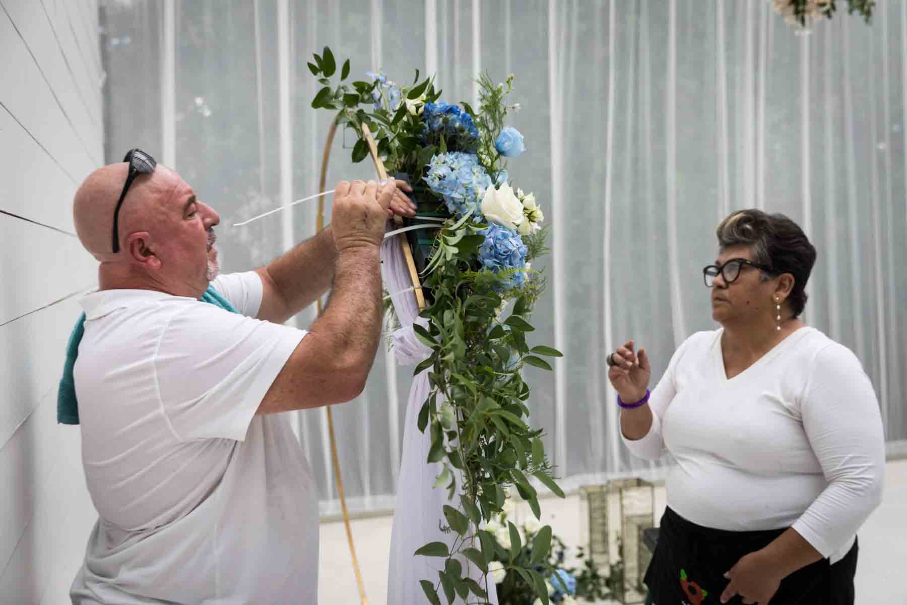 Floral team at Ay Poppy! putting together a wedding ceremony arrangement for an article on how to choose the perfect flowers for your wedding or event