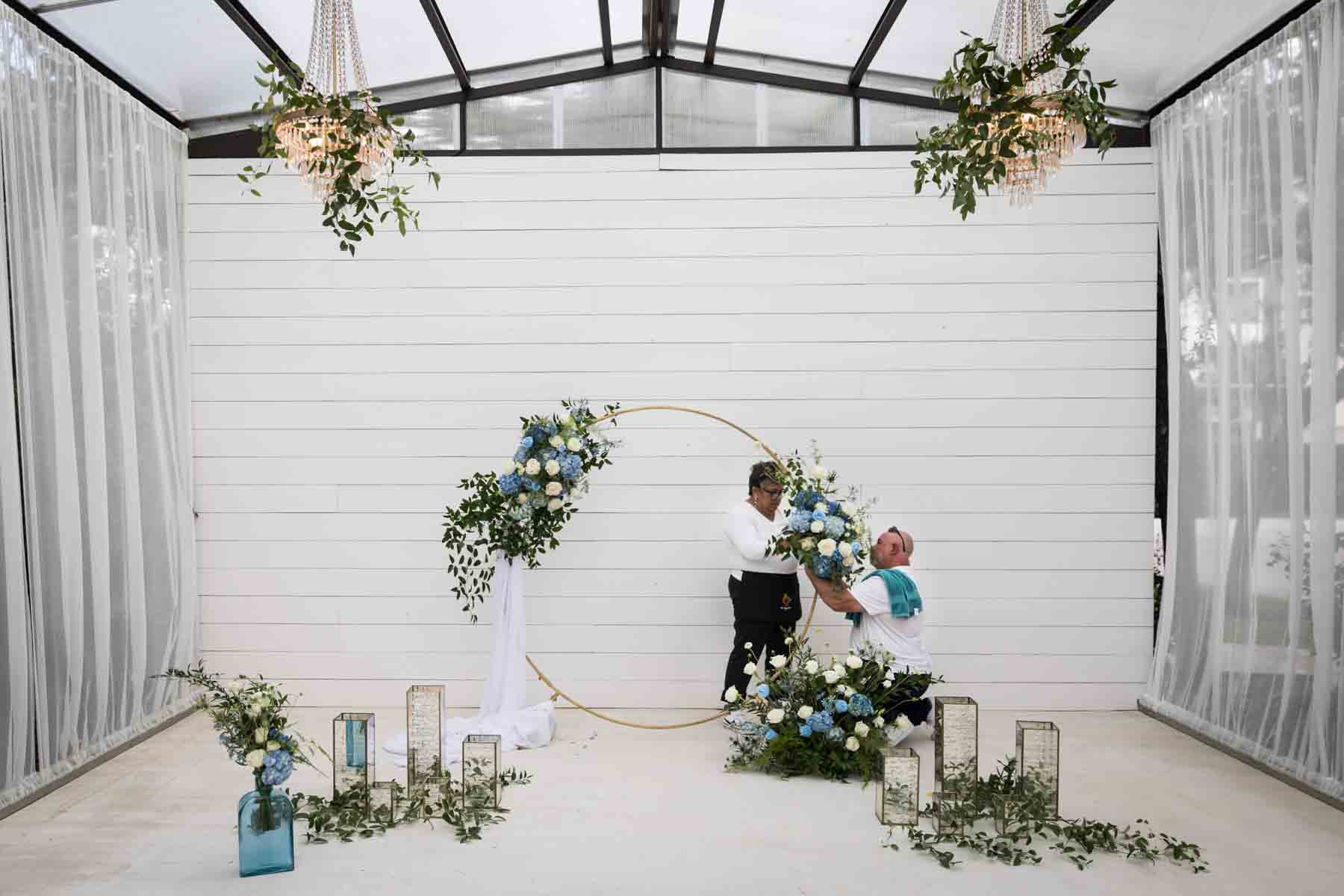 Floral team at Ay Poppy! putting together a white and blue floral arrangement for an article on how to choose the perfect flowers for your wedding or event