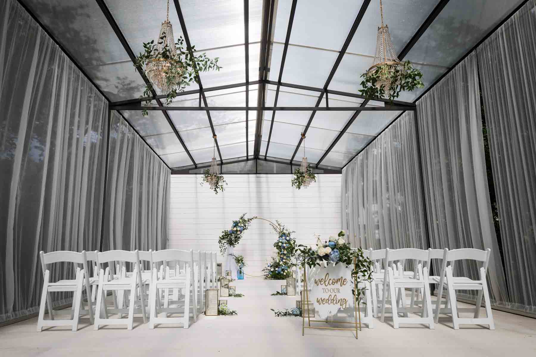 Finished white and blue wedding ceremony floral display with aisle decorations for an article on how to choose the perfect flowers for your wedding or event