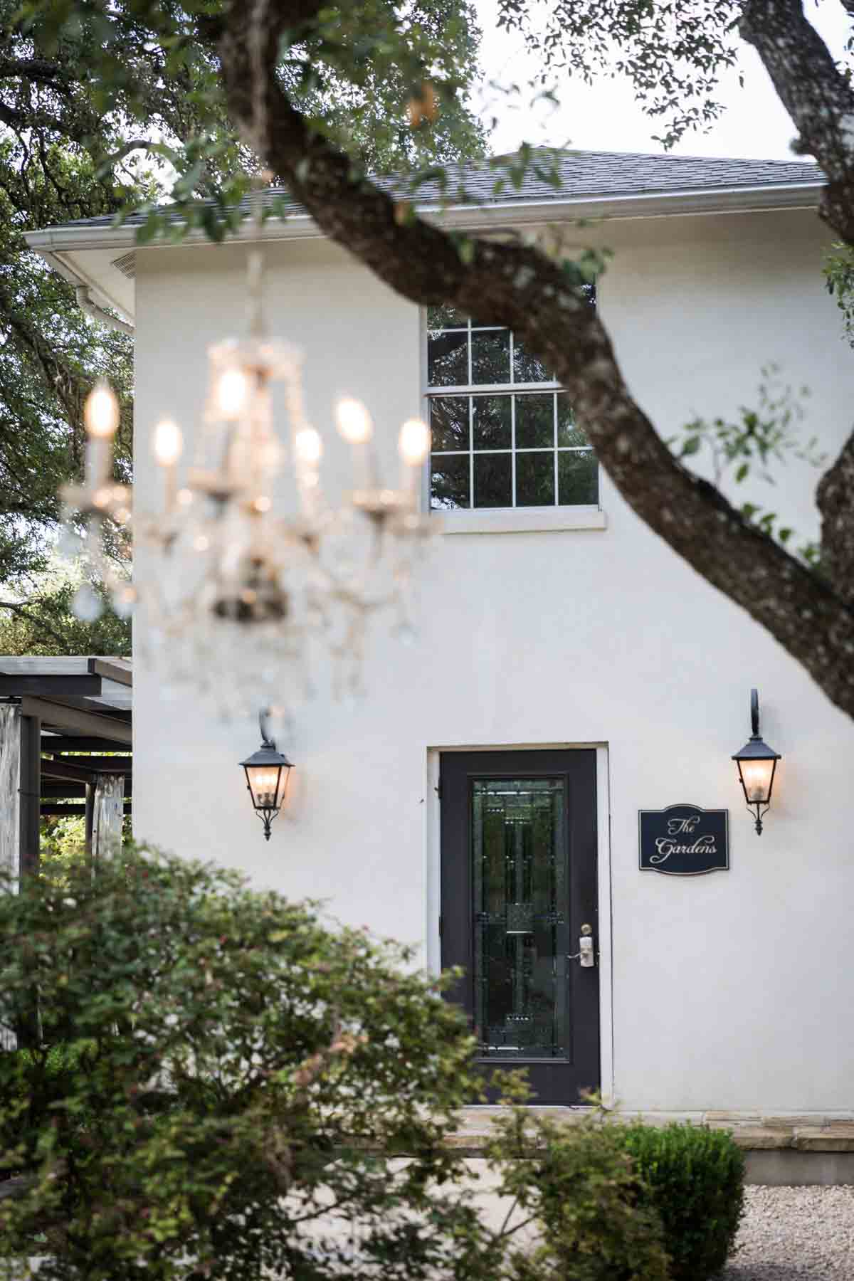 Exterior of house with chandelier in the foreground blurry