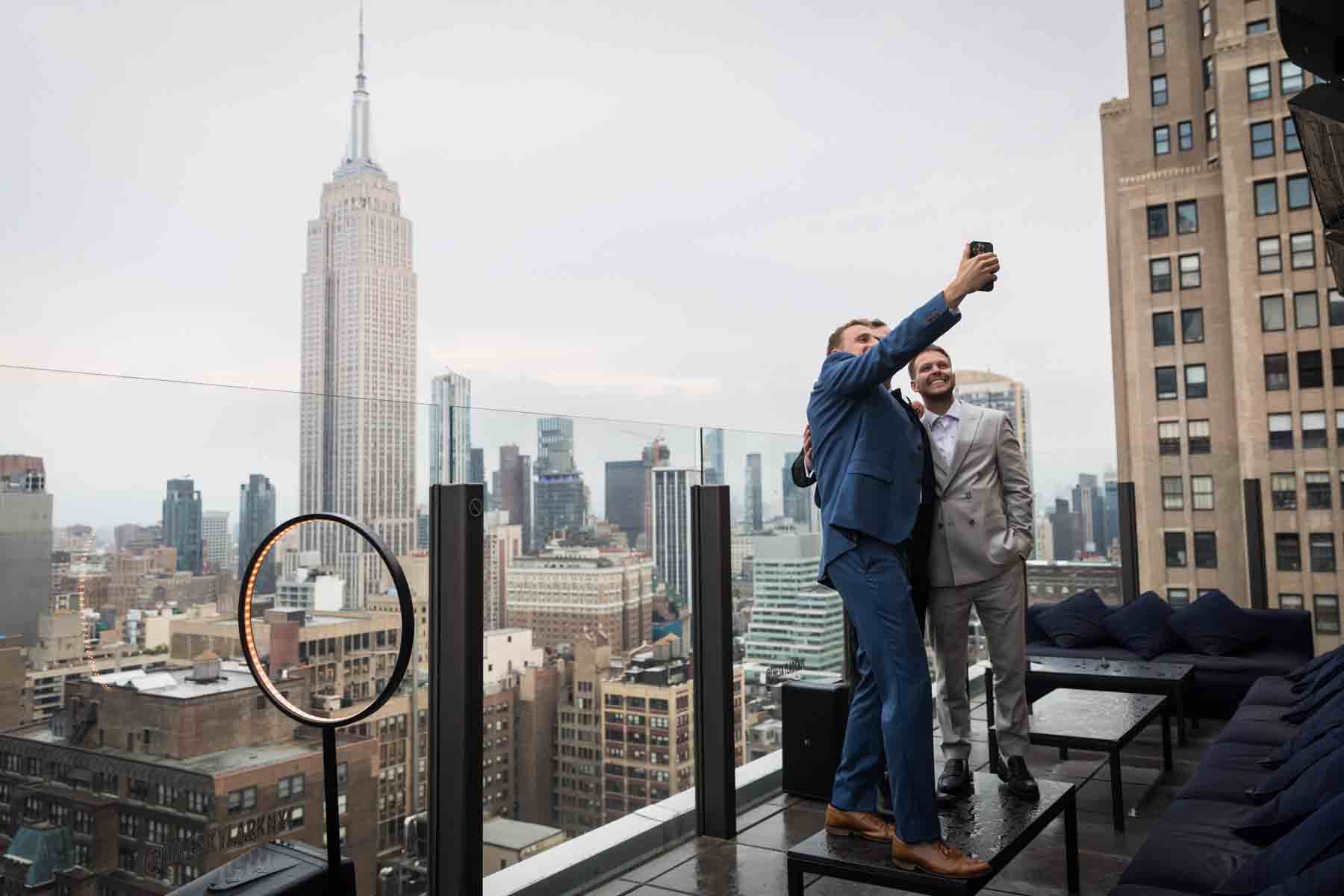 Group of guests taking a selfie in front of Empire State Building at a wedding reception for an article on how to take the perfect selfie