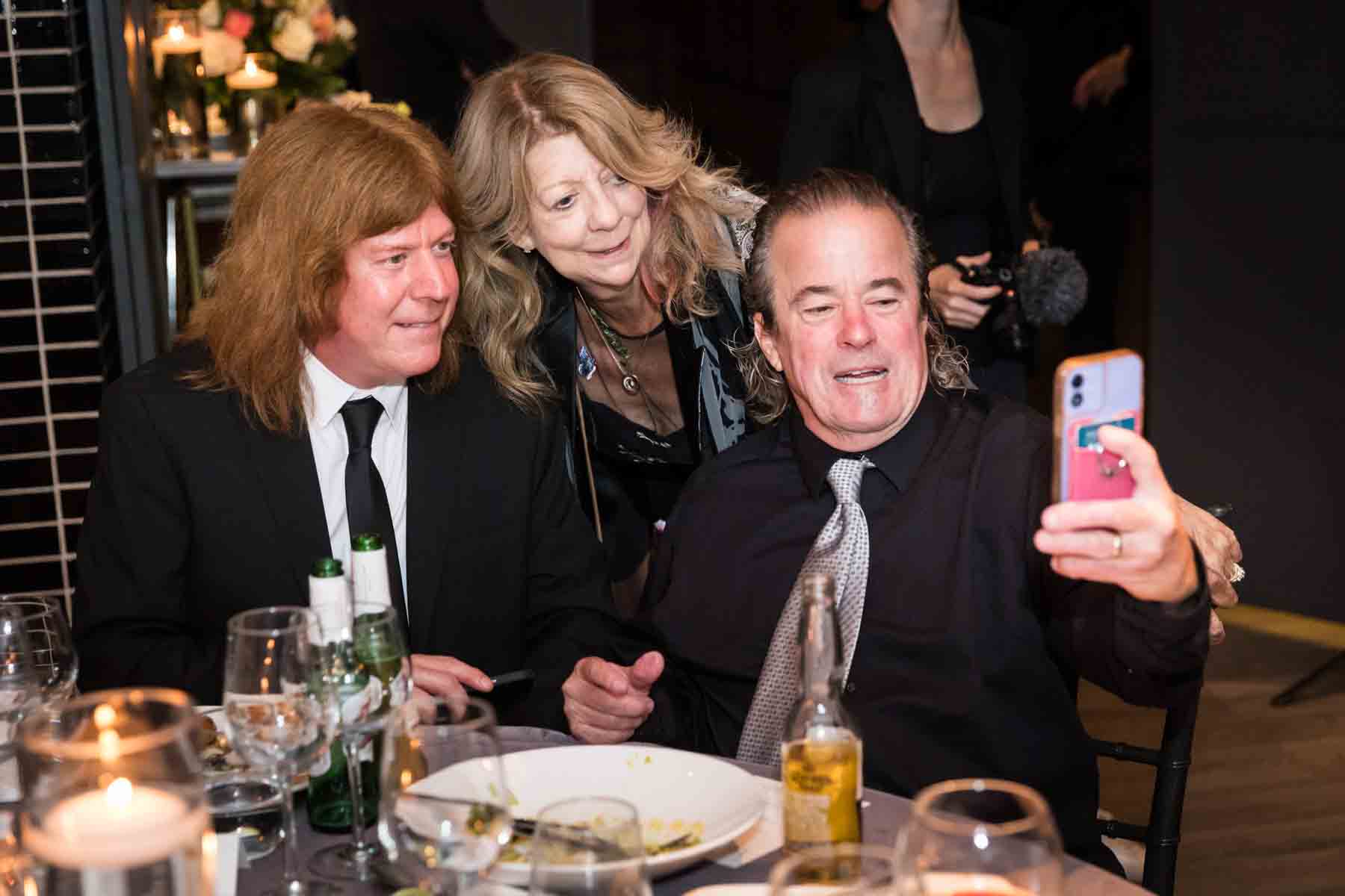 Group of guests taking a selfie at a wedding reception for an article on how to take the perfect selfie