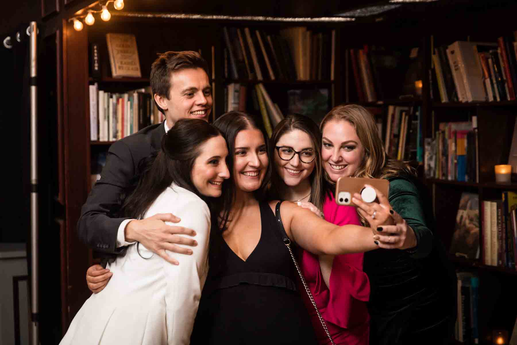 Group of guests taking a selfie at a wedding reception for an article on how to take the perfect selfie