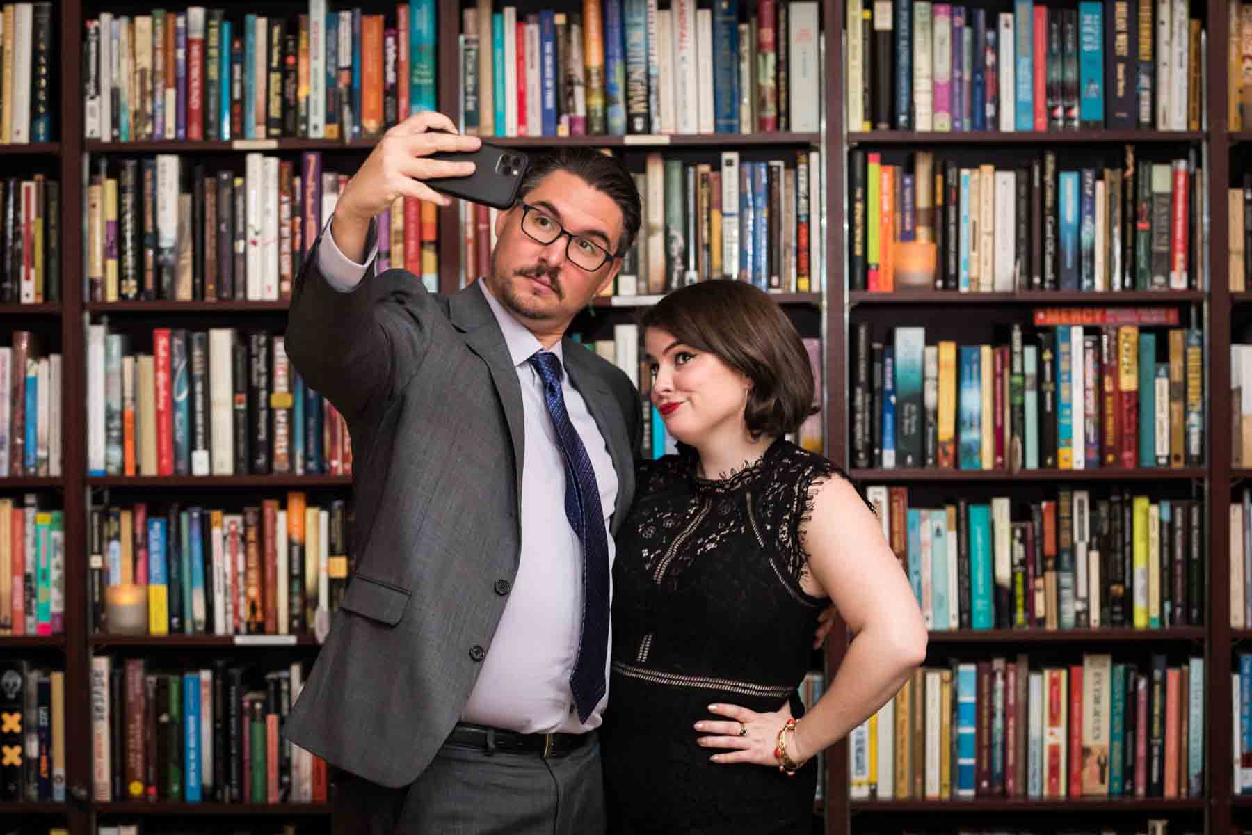 Two guests taking a selfie at a wedding reception for an article on how to take the perfect selfie